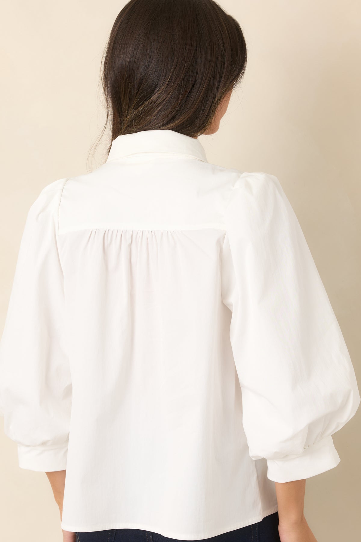 Rear of the blouse showing subtle gathers across the shoulders and back with a relaxed silhouette.
