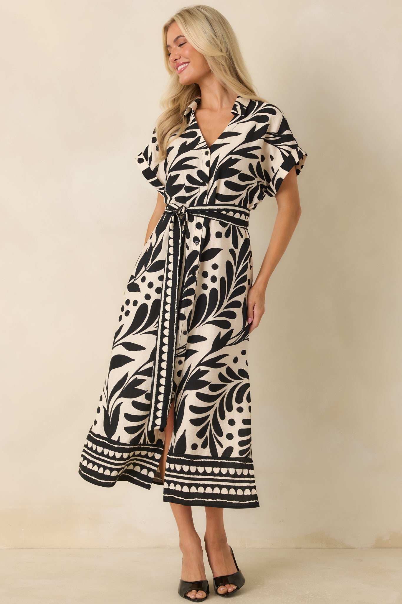 Relaxed button-front midi dress featuring bold botanical print, dolman sleeves with cuffs, and lightweight woven construction.
