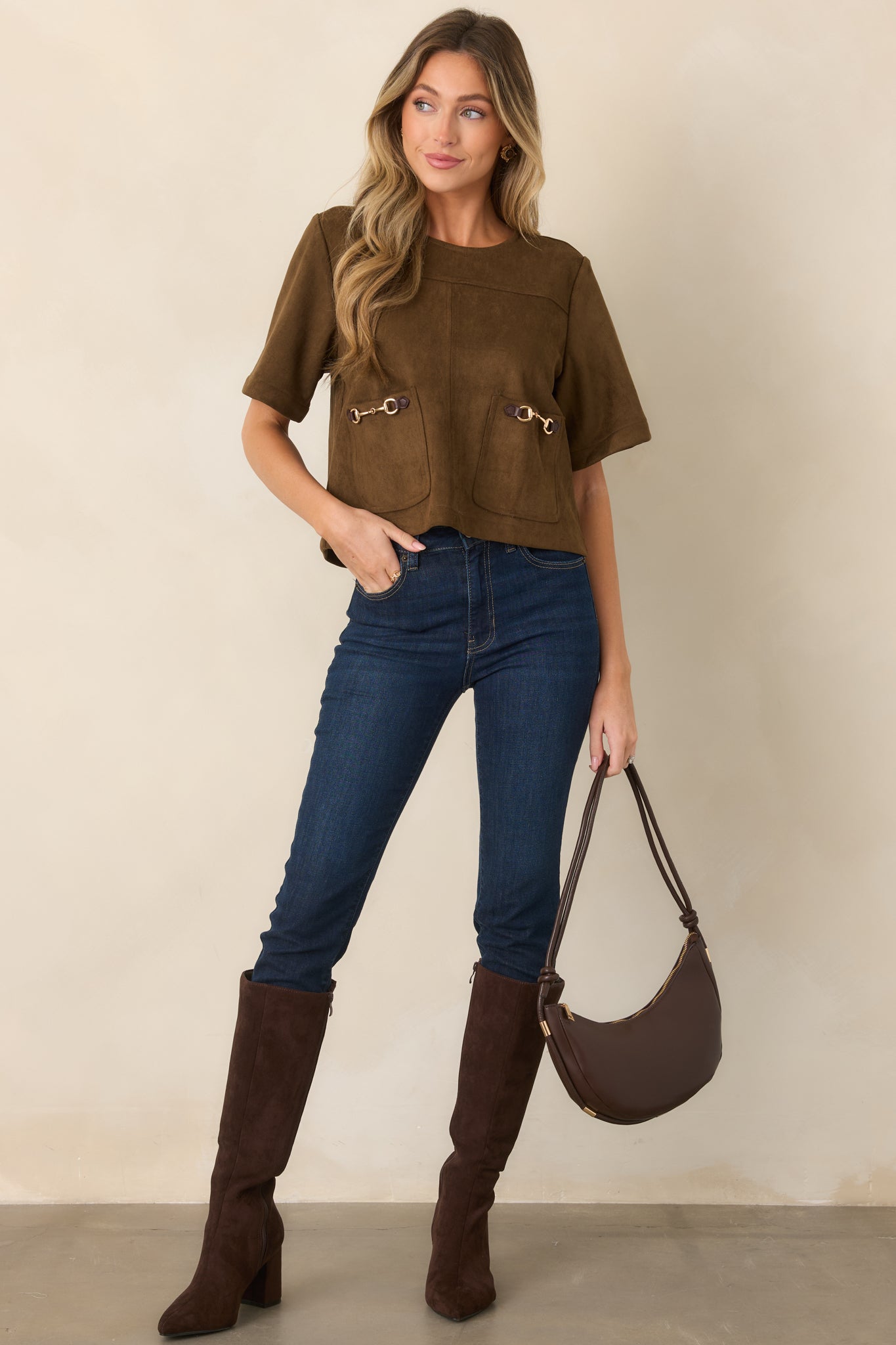 Relaxed boxy top with short sleeves, a simple round neckline, and oversized pockets accented with decorative horsebit hardware.