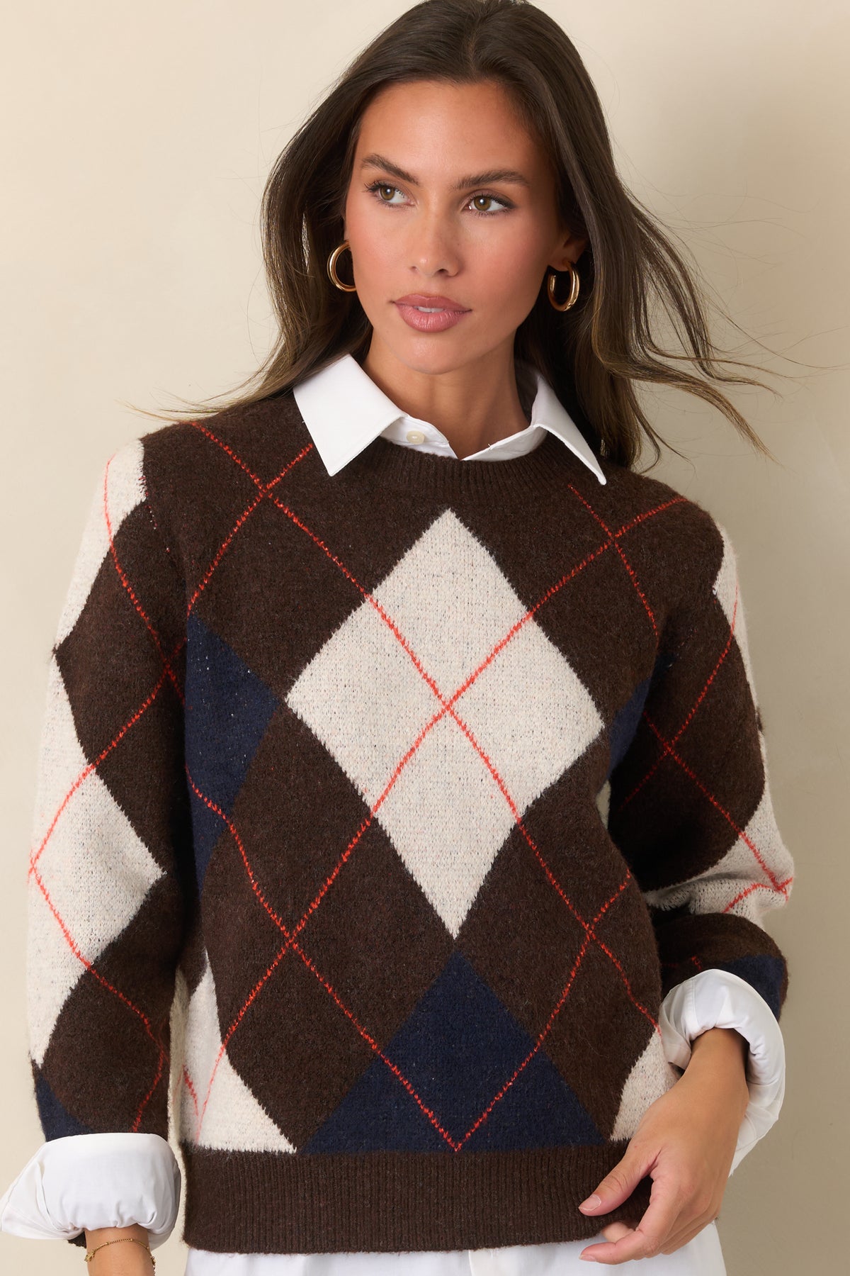 Relaxed brown top with an intricate diamond pattern in ivory and navy, accented by narrow rust-red lines and finished with ribbed edges.