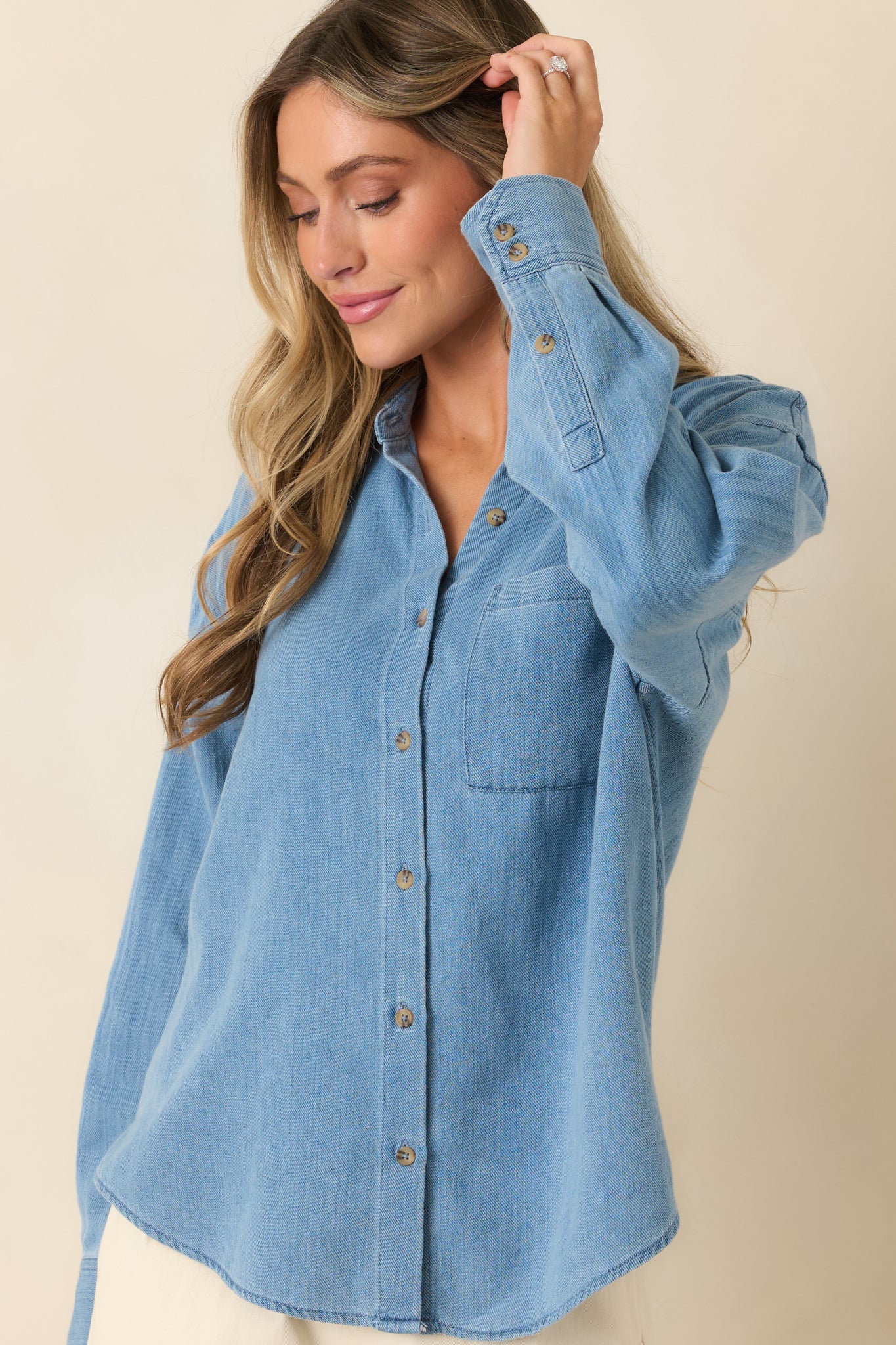 Relaxed button-up shirt featuring a curved hem and thoughtfully tailored front details.
