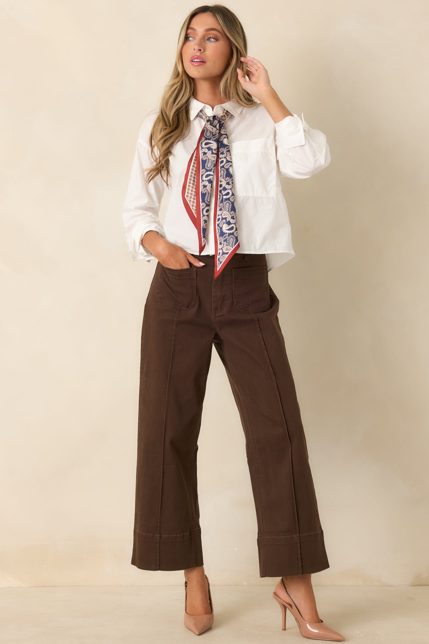Relaxed cotton shirt featuring a functional button-front closure, collared neckline, and versatile cropped design.