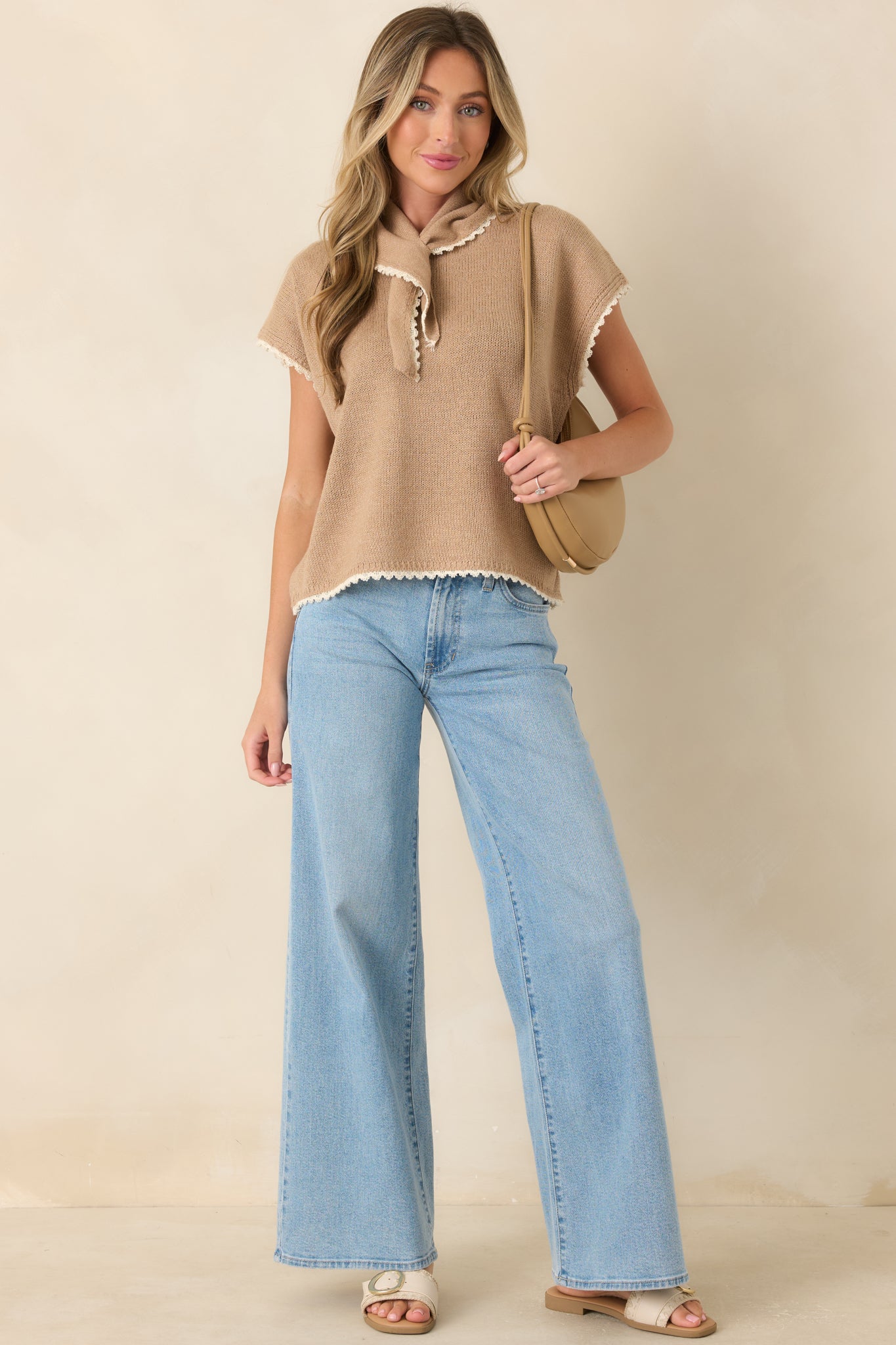 Relaxed cotton top featuring a draped scarf neckline, contrast trim along the sleeves and hem, and a clean knit finish.