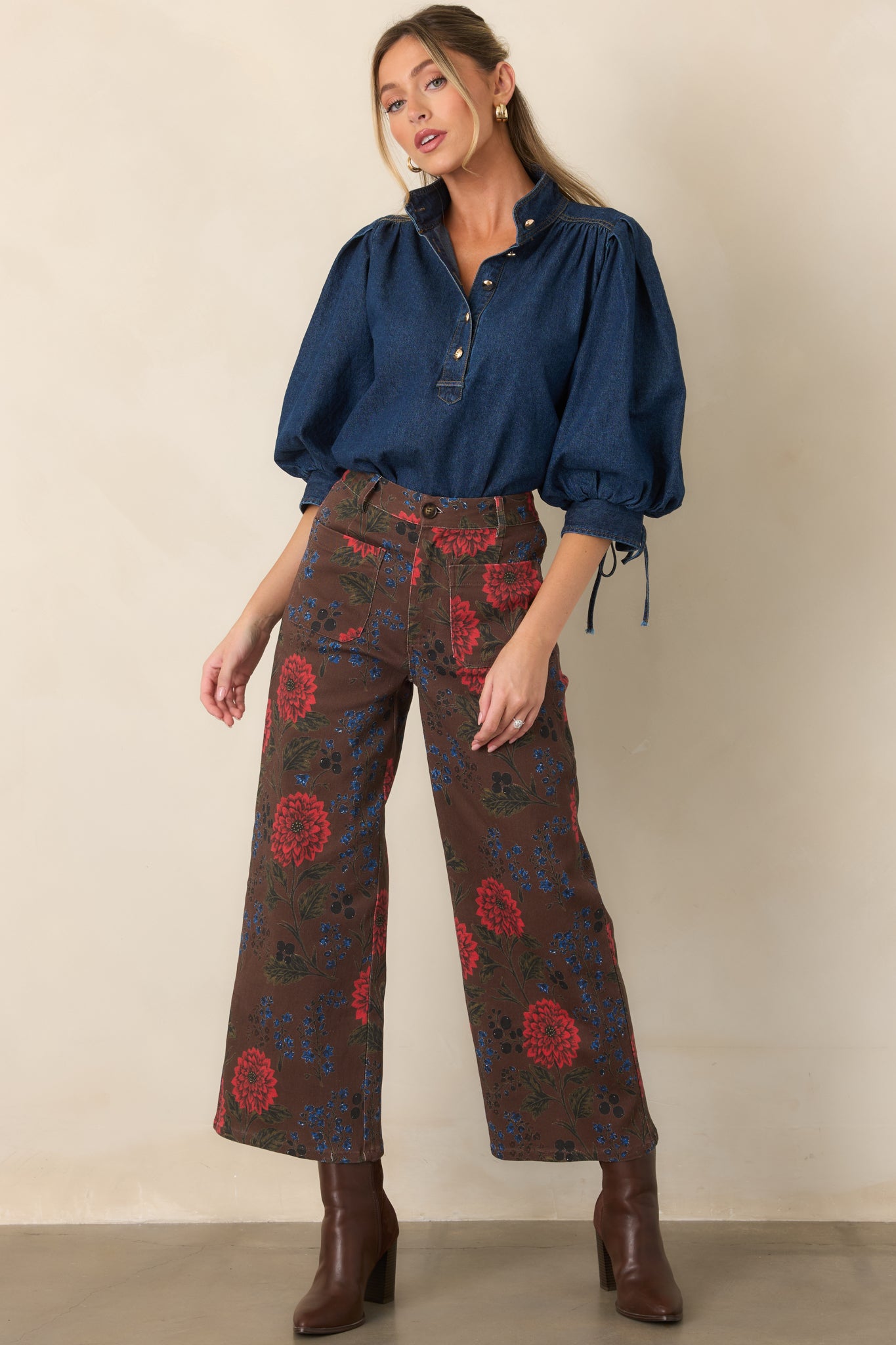 Relaxed denim top designed with a collared neckline, partial buttons, voluminous sleeves, and an easy high-low silhouette.