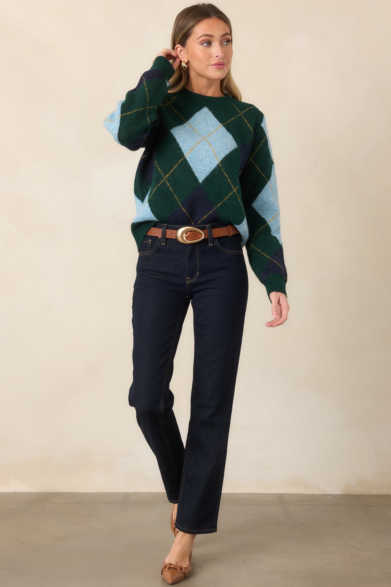 Relaxed sweater showcasing geometric diamond accents, golden yellow detailing, long sleeves, and ribbed trim along the neckline, cuffs, and hem.