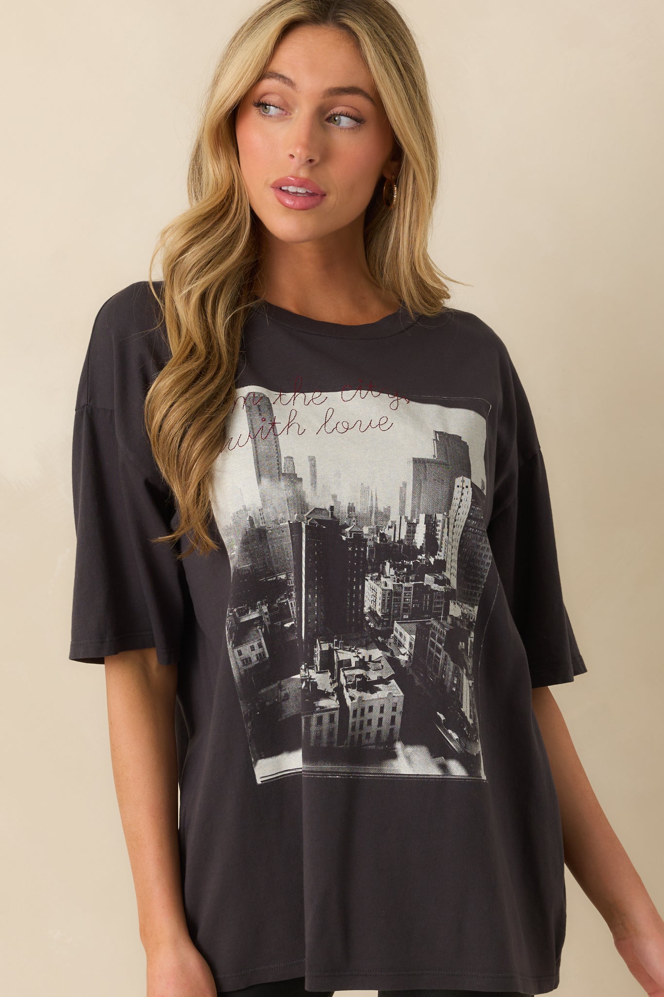 Relaxed fit and fabric texture of the black tee with embroidered lettering.