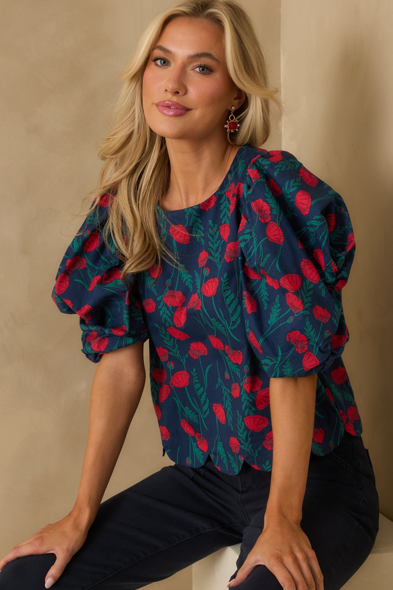 Relaxed fit blouse featuring puff short sleeves and a round neckline.