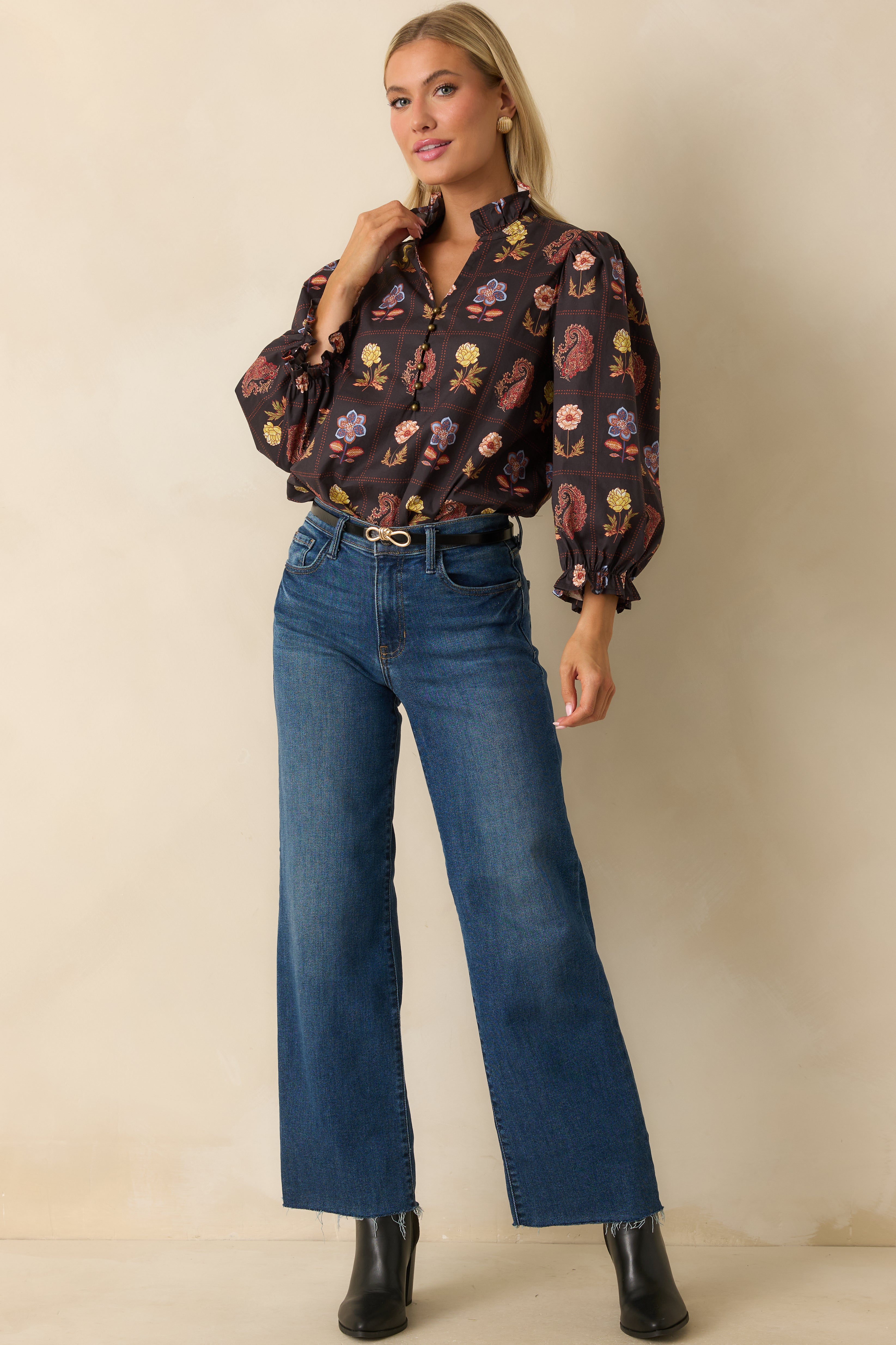 Relaxed-fit blouse featuring lightweight woven fabric, metallic buttons, and elastic ruffle cuffs.