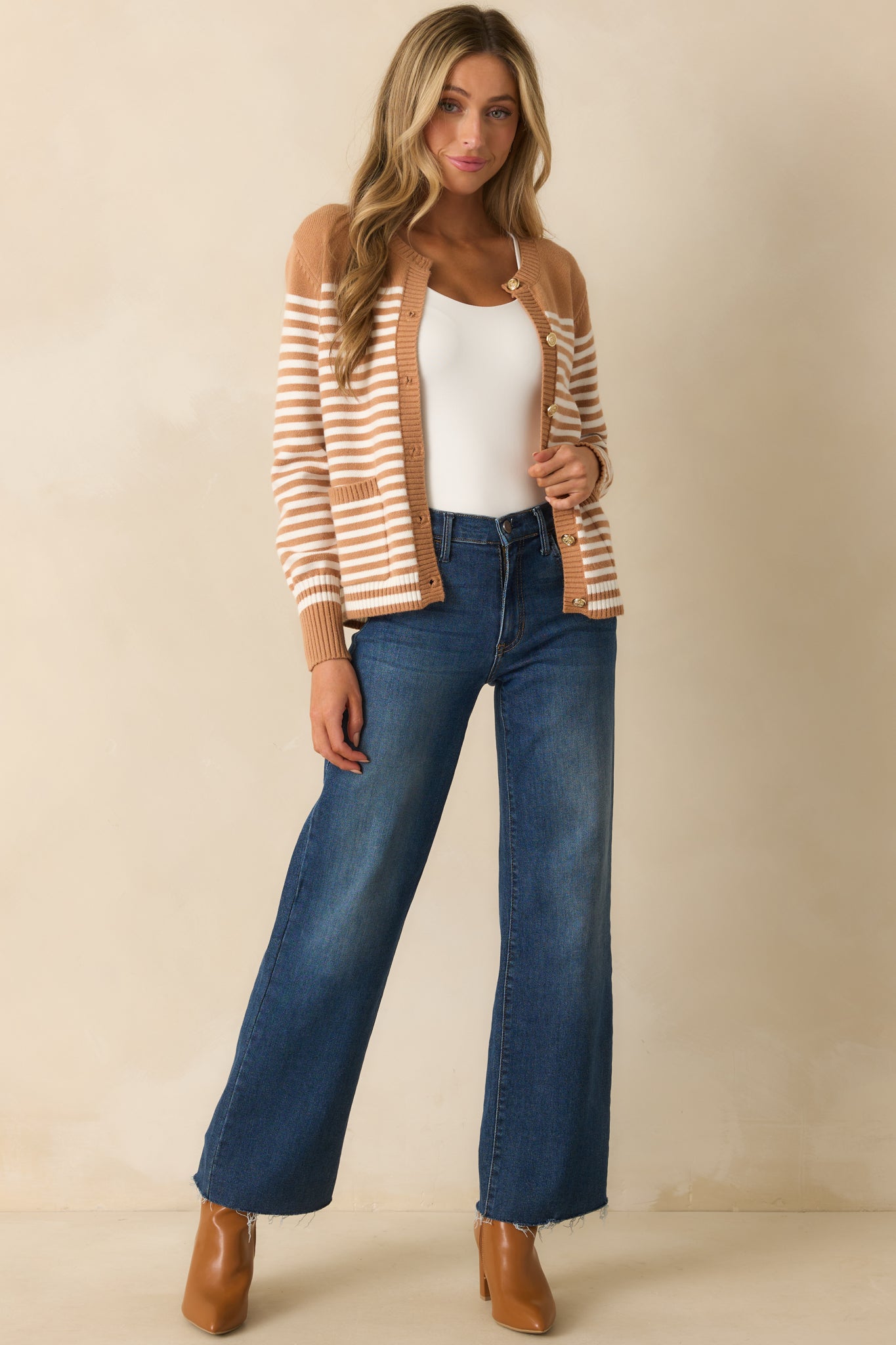 Relaxed-fit camel cardigan with horizontal ivory stripes and functional front closure buttons.