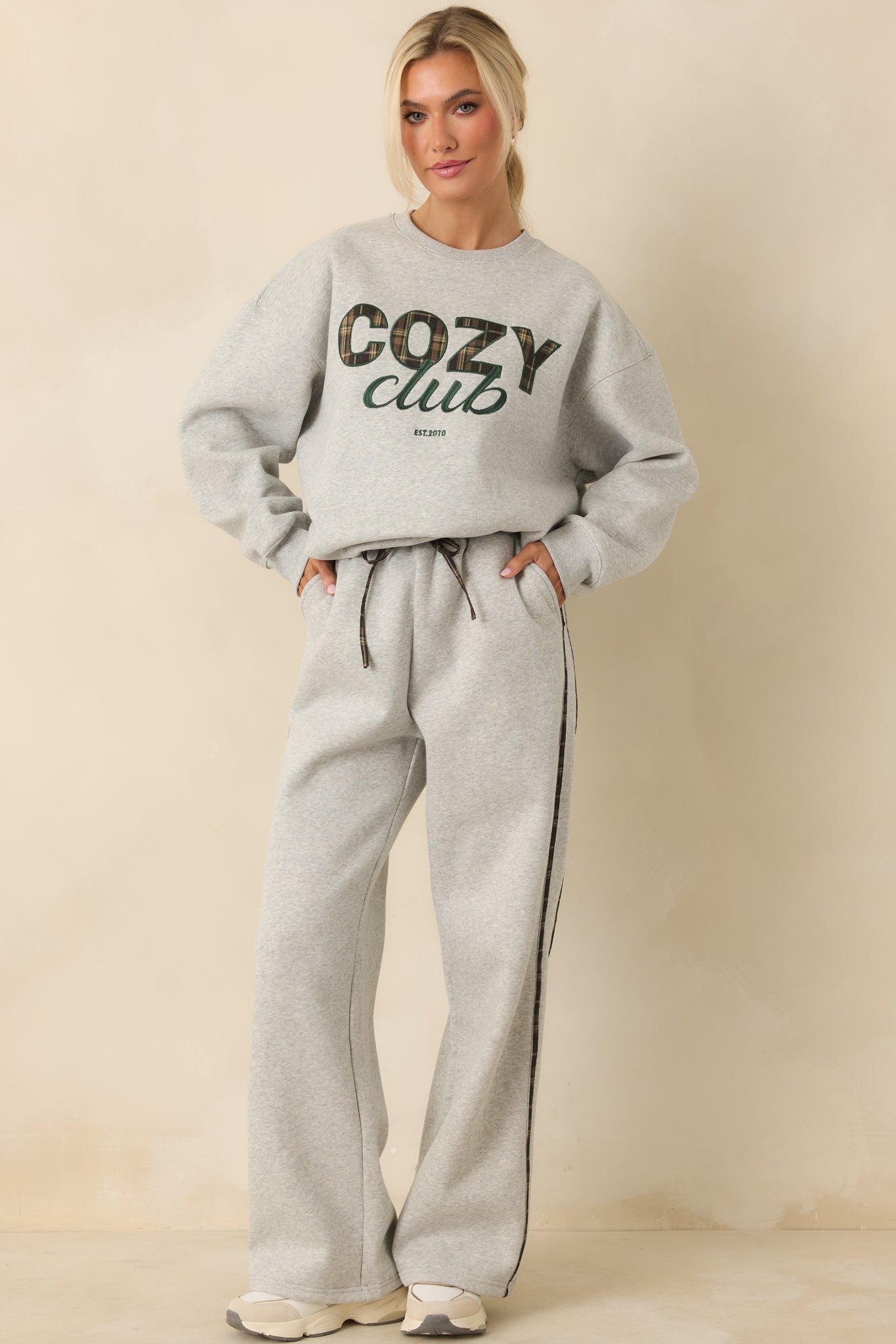 Relaxed fit grey pull-on sweatpants with straight-leg silhouette and side stripe detailing.
