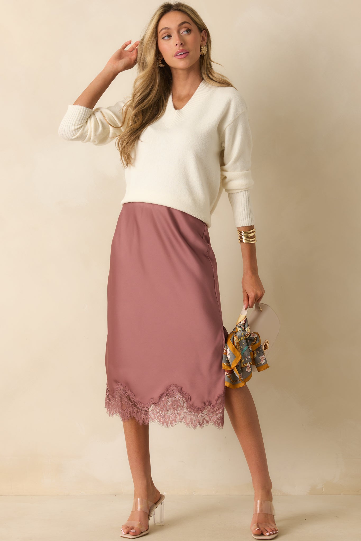 Relaxed-fit ivory sweater with ribbed cuffs, polished v-neck, and cozy knit fabric.