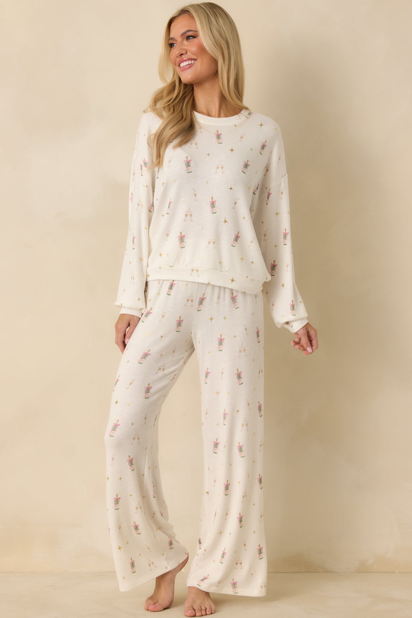 Relaxed fit ivory top featuring smooth brushed knit and subtle shine in the pattern.