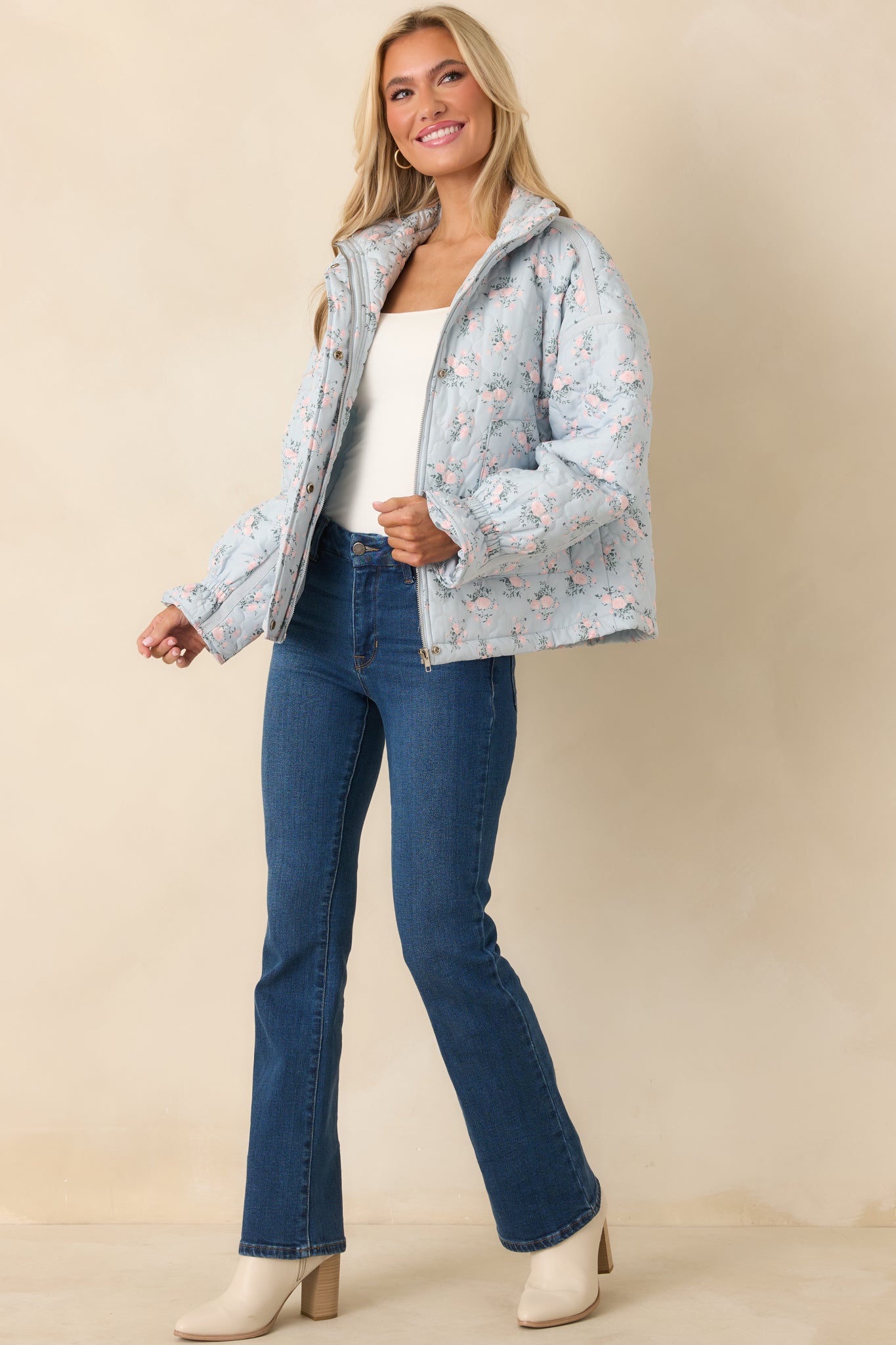 Relaxed-fit light blue jacket with pink floral and green foliage quilting, high collar, and snap-button closure for everyday wear.