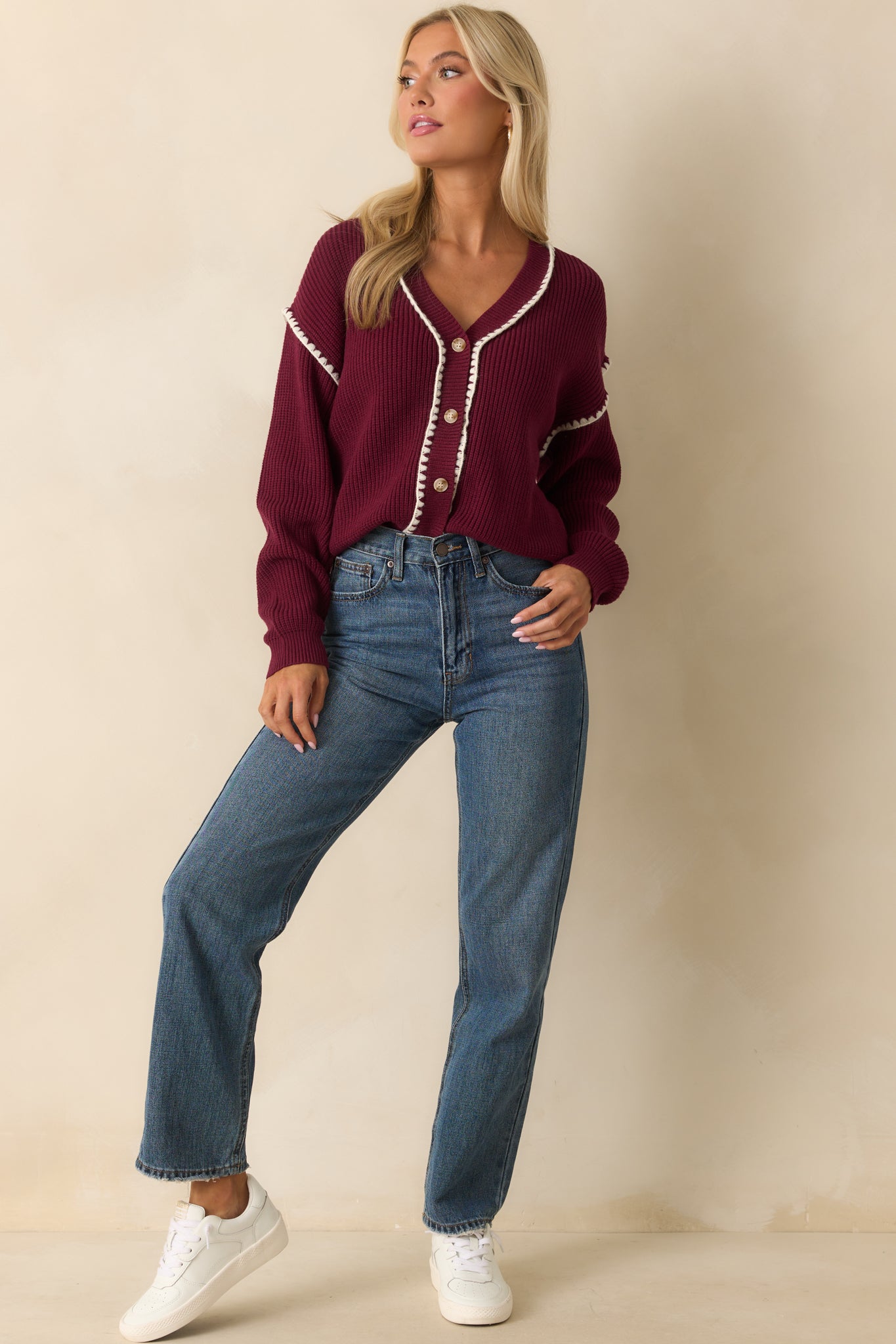 Relaxed fit maroon cardigan with ribbed construction and button front design.