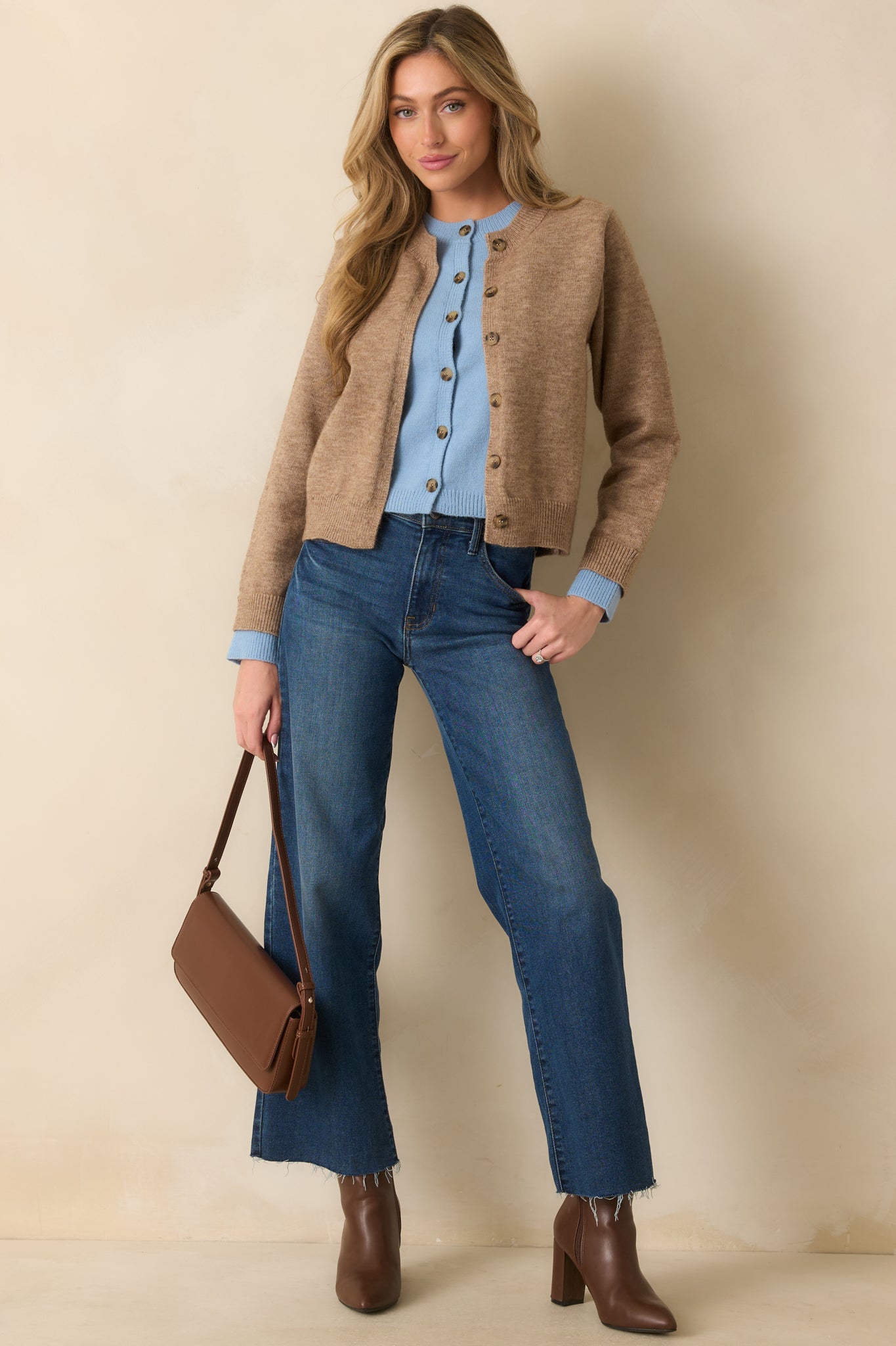 Relaxed-fit cardigan in soft mocha featuring long sleeves and a casual layered look with contrasting light blue trim.