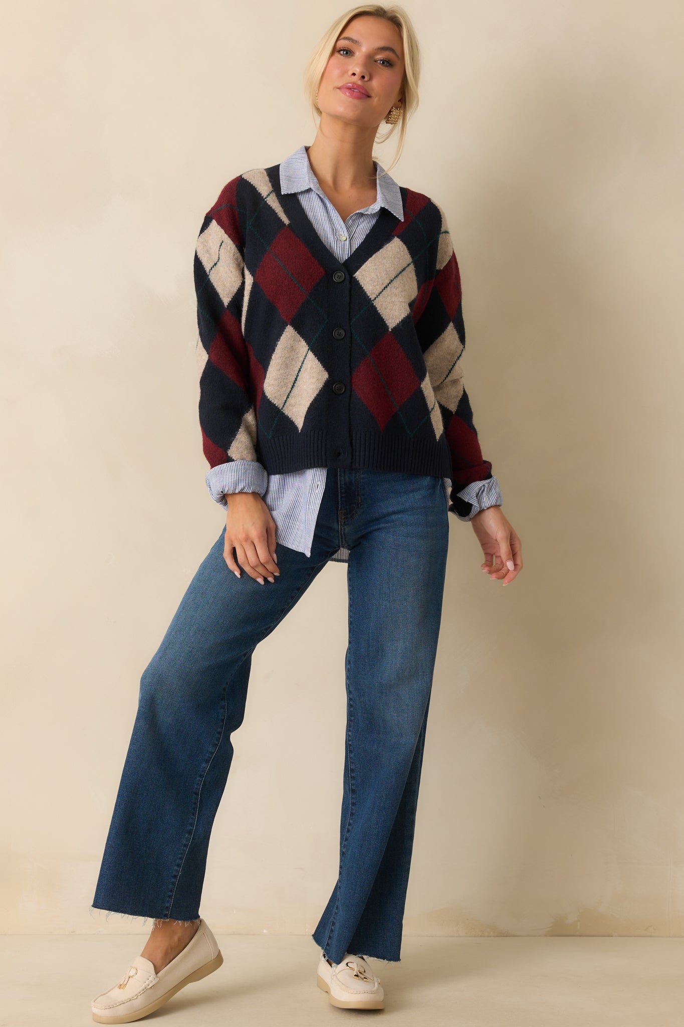Relaxed fit navy cardigan with classic argyle design and full-length sleeves.