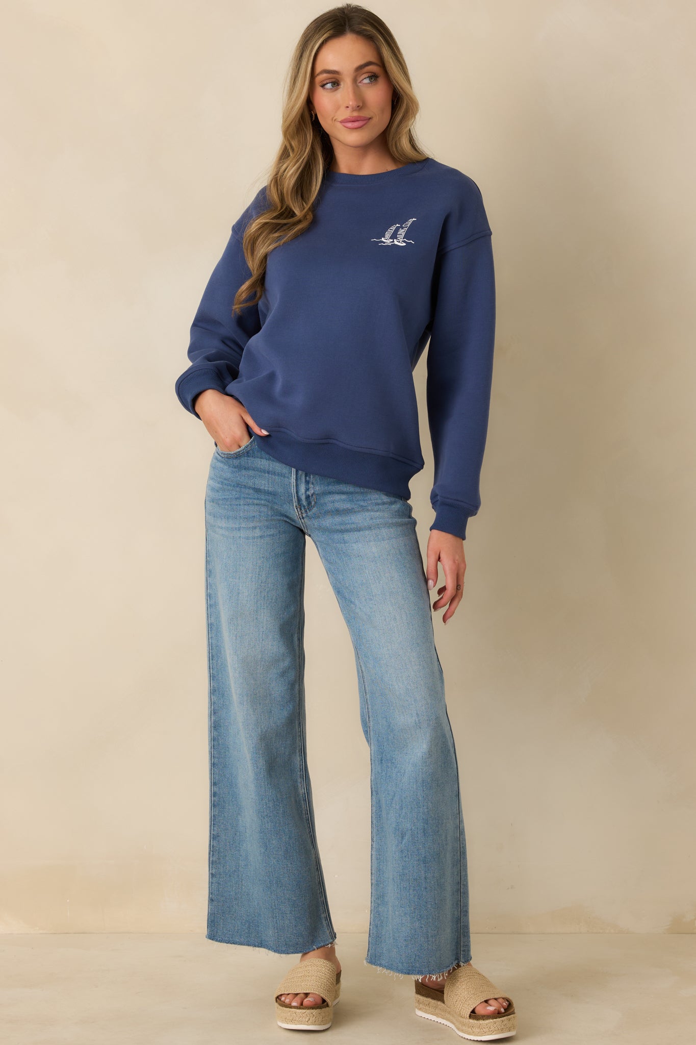 Relaxed-fit navy crewneck sweatshirt showcasing long sleeves and clean, timeless silhouette with subtle ribbed detailing.