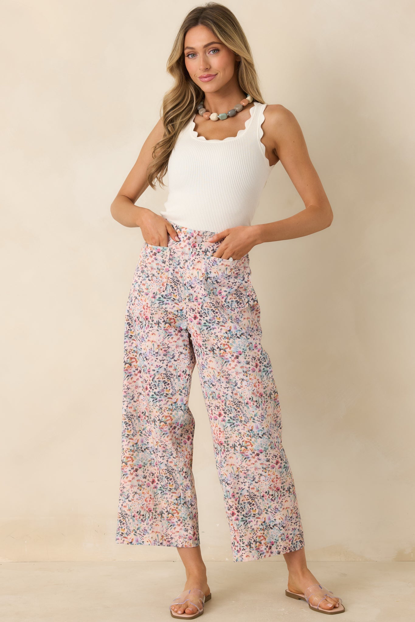 Relaxed floral pants featuring button-front closure and breathable textured cotton fabric.