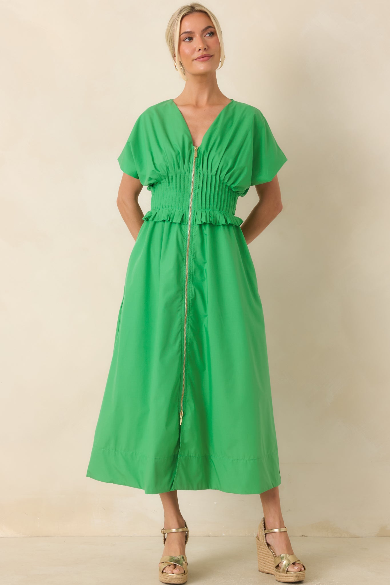 Relaxed green maxi dress showcasing a smocked waistband, ruffled trim, and flowing silhouette.