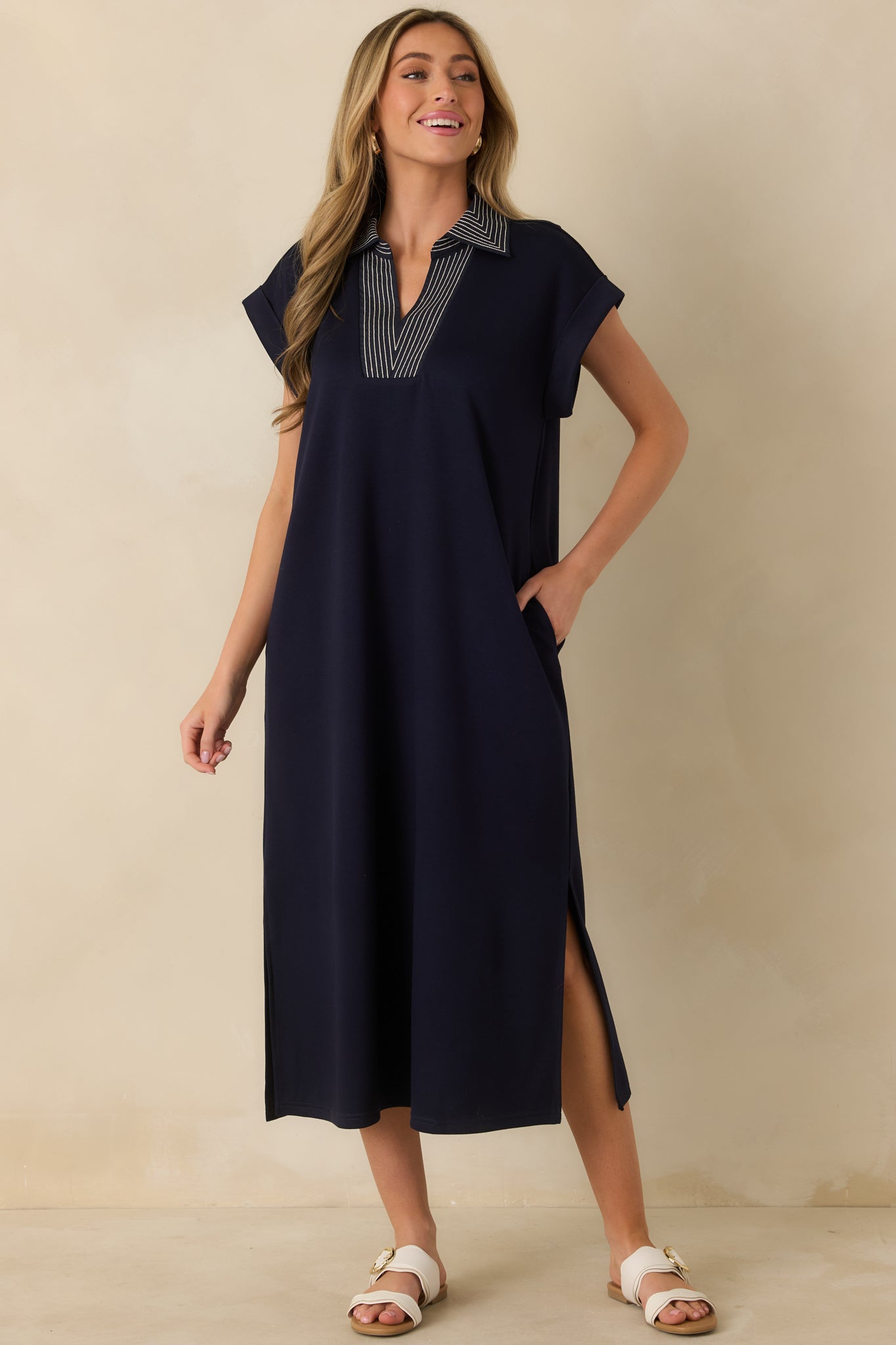 Relaxed navy knit midi dress featuring a flattering V-neckline and side slits for natural movement.