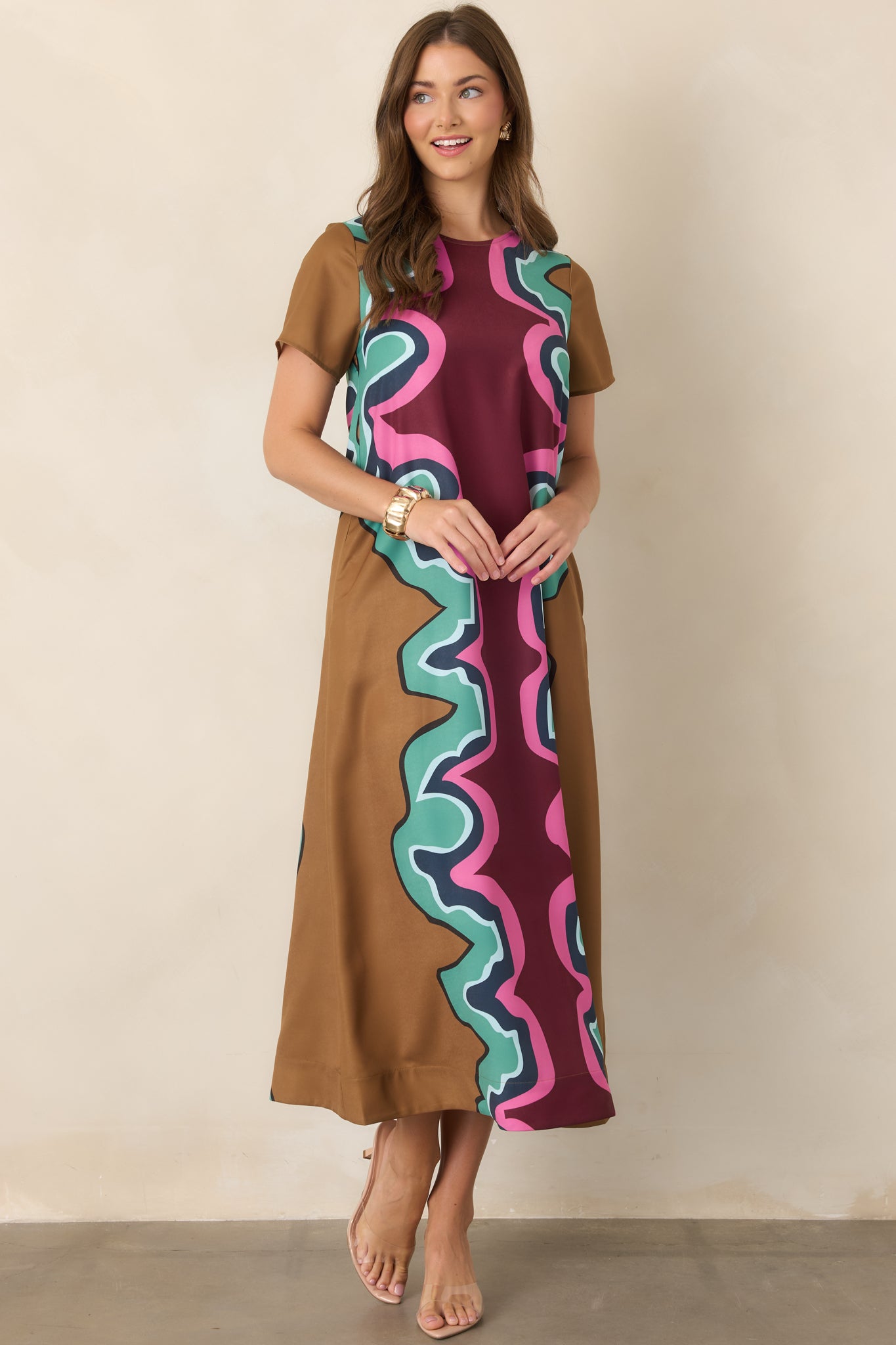 Relaxed maxi dress displaying an intricate serpentine motif across the fabric, complemented by a classic round neckline and short sleeves.