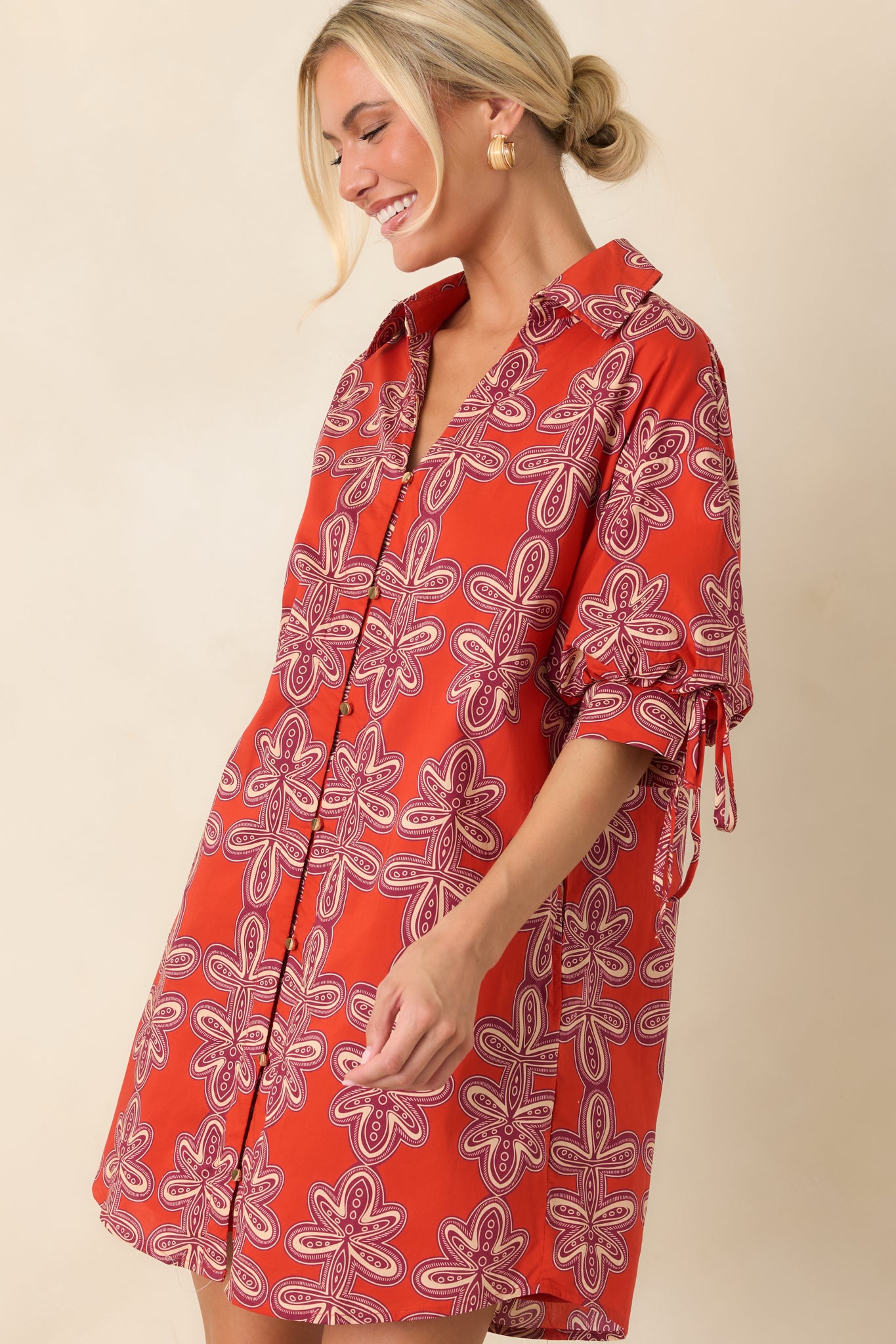 Relaxed silhouette pairs with a classic collar and button-front closure for a timeless mini shirt dress design.