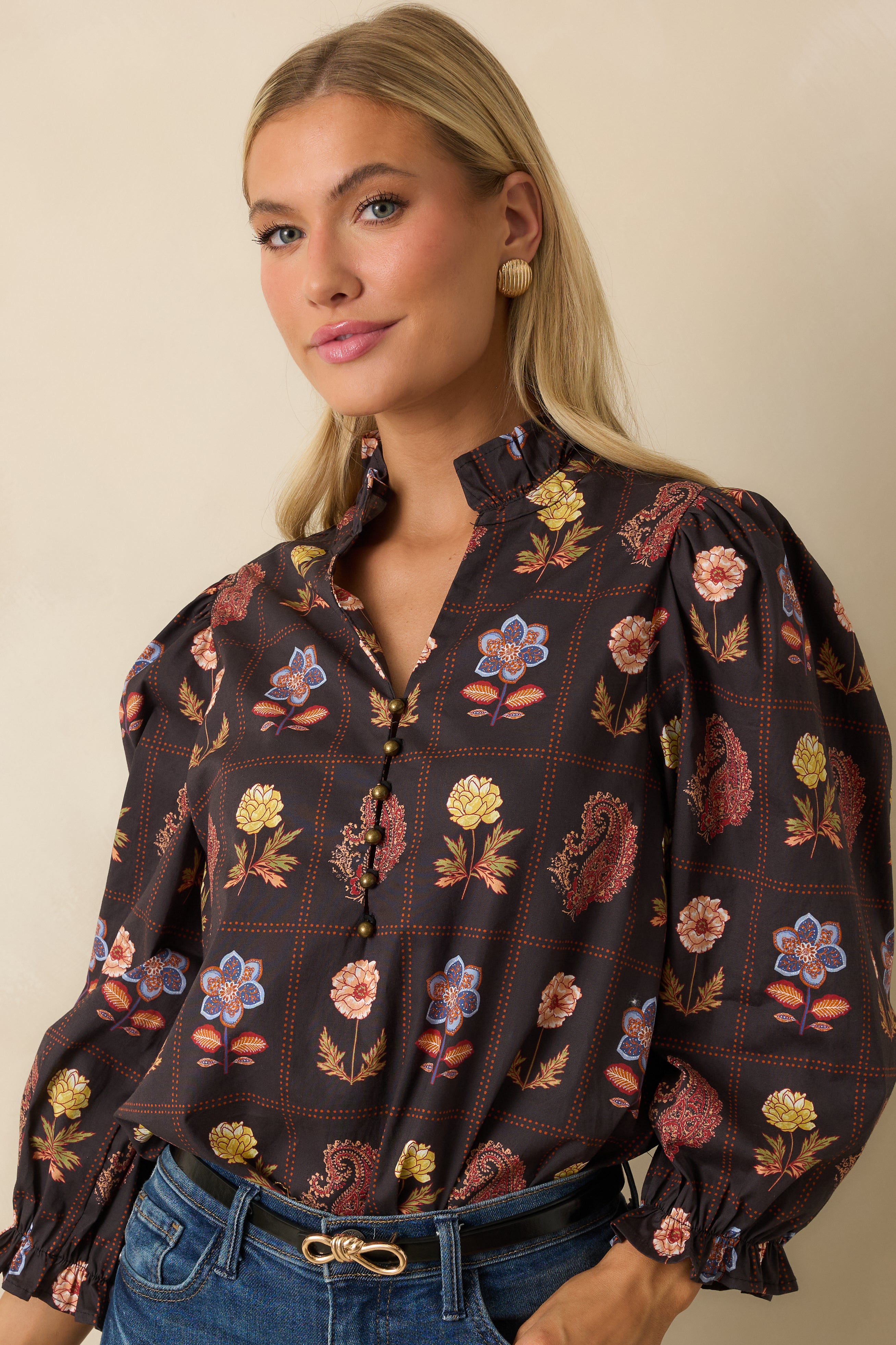 Focus on the relaxed silhouette and multicolor floral print on the black blouse.
