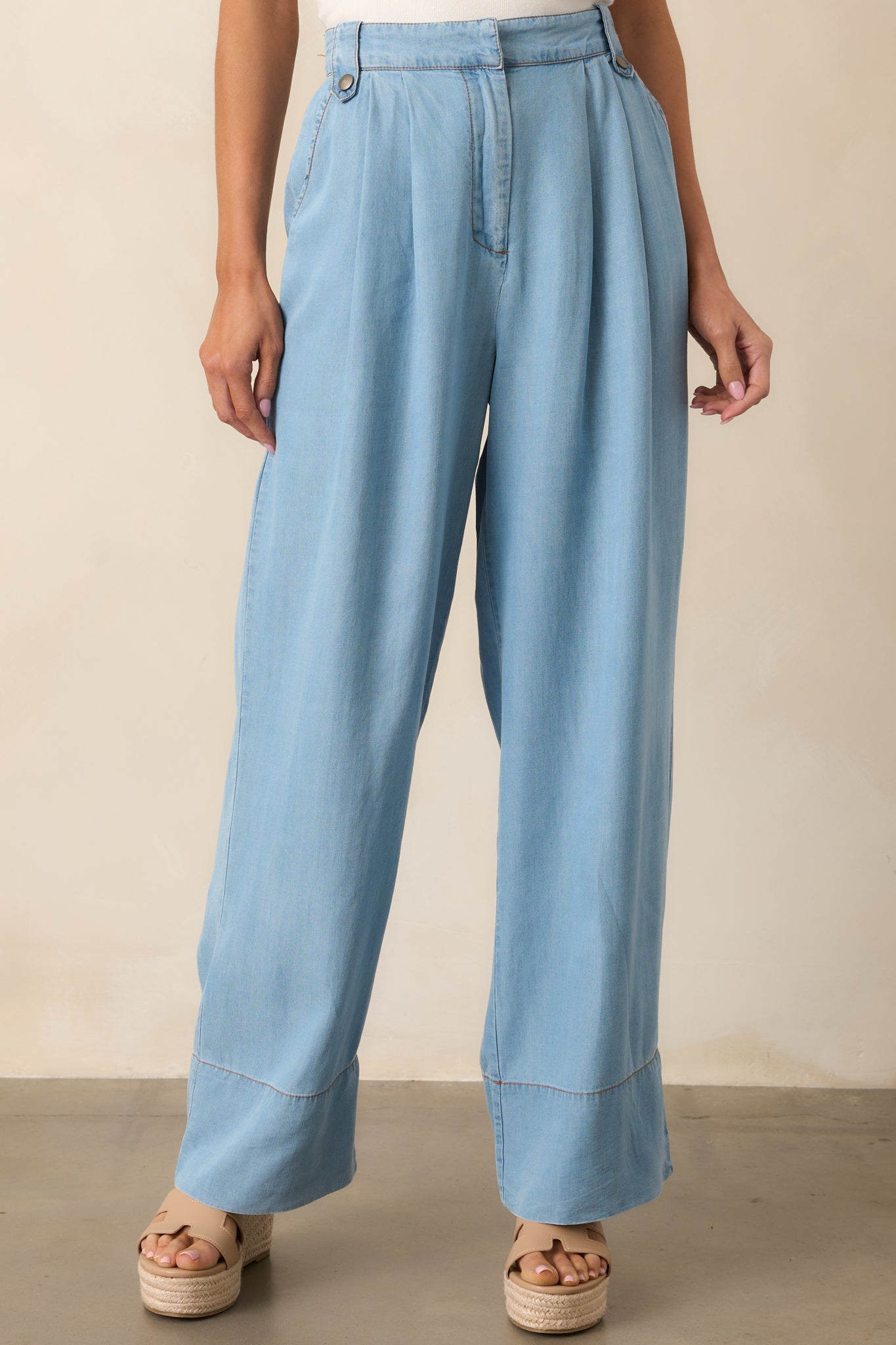 The structured yet relaxed wide-leg design adds movement and polish to these high-rise pants.