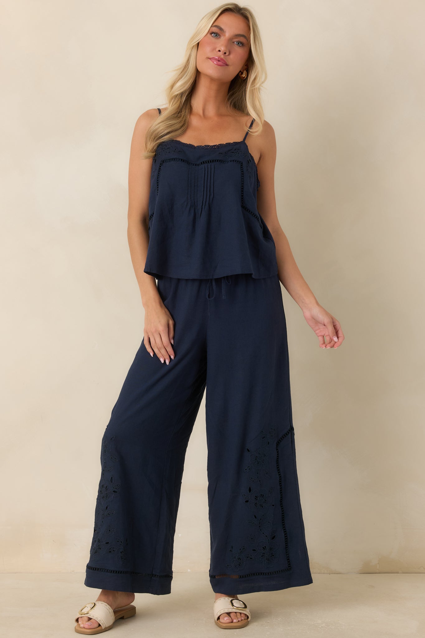 Relaxed wide leg pants showcasing artisanal floral accents and a softly textured finish.