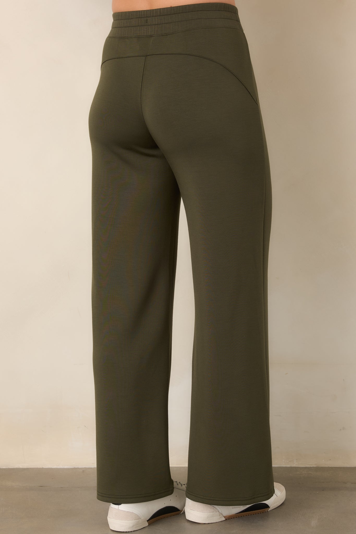 Rear view of the relaxed wide-leg pants showcasing the smooth pull-on waistband and fluid drape through the legs.