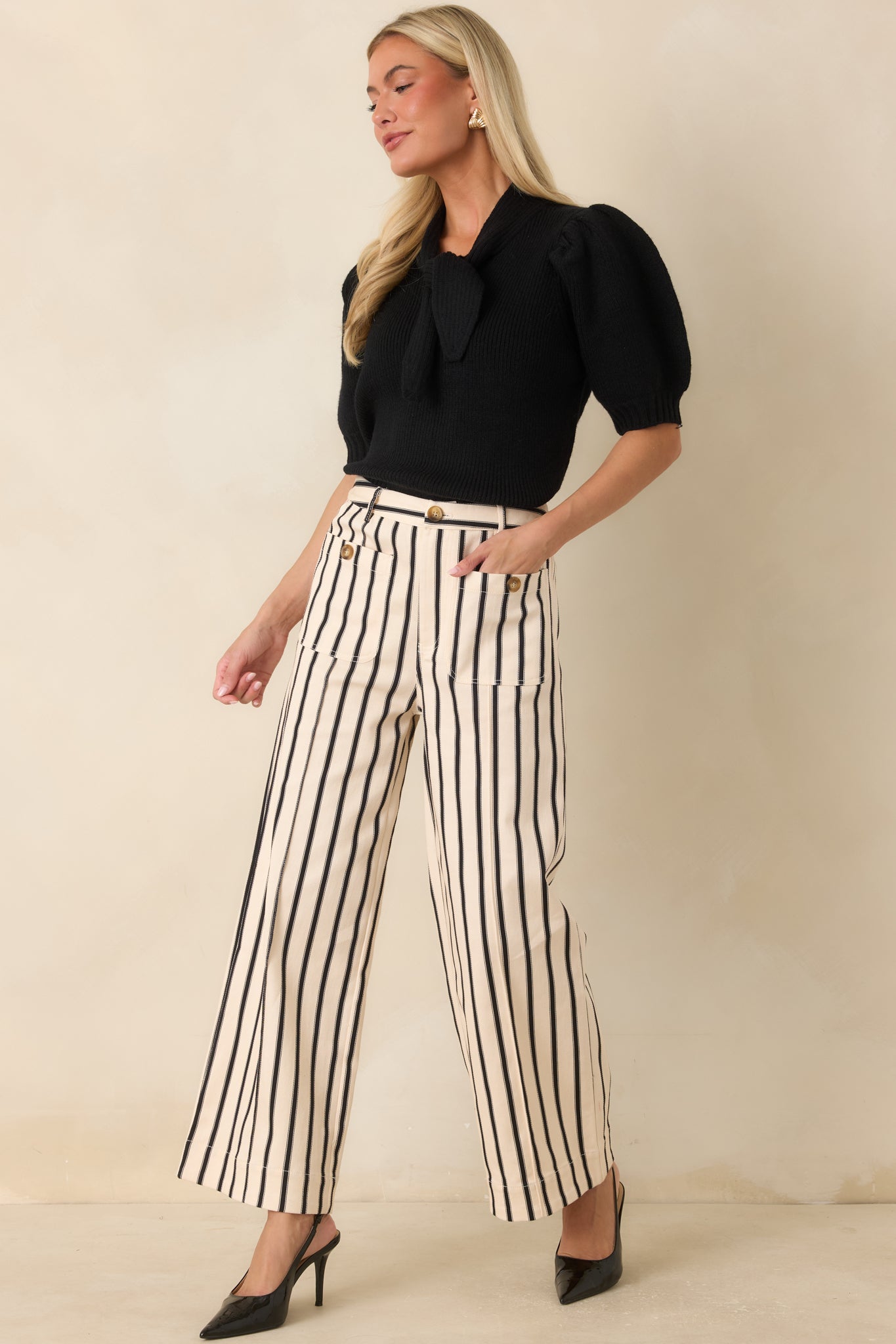 Relaxed wide-leg pants crafted from a cotton blend with vertical stripes, belt loops, and a polished tailored design.