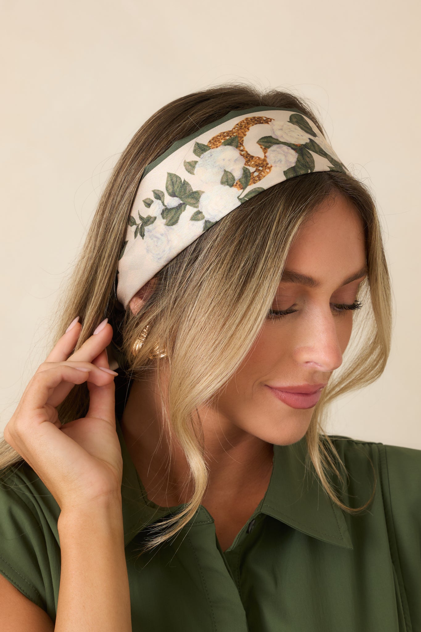 Reversible silk accessory showcasing elegant floral and diamond patterns with rich green tones and a polished finish.