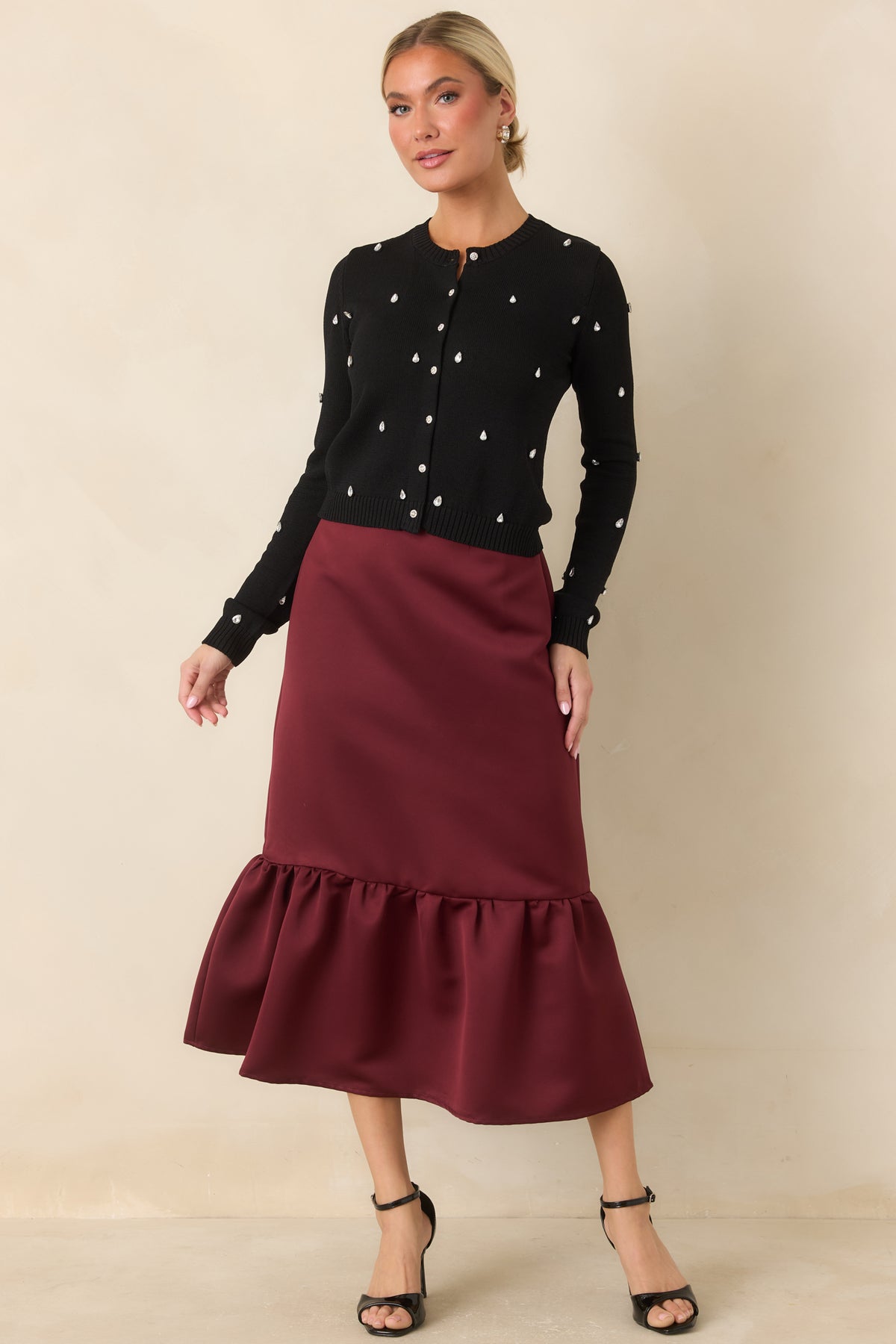 Slightly cropped cardigan featuring a classic crew neckline, jeweled sleeves, and ribbed trim.
