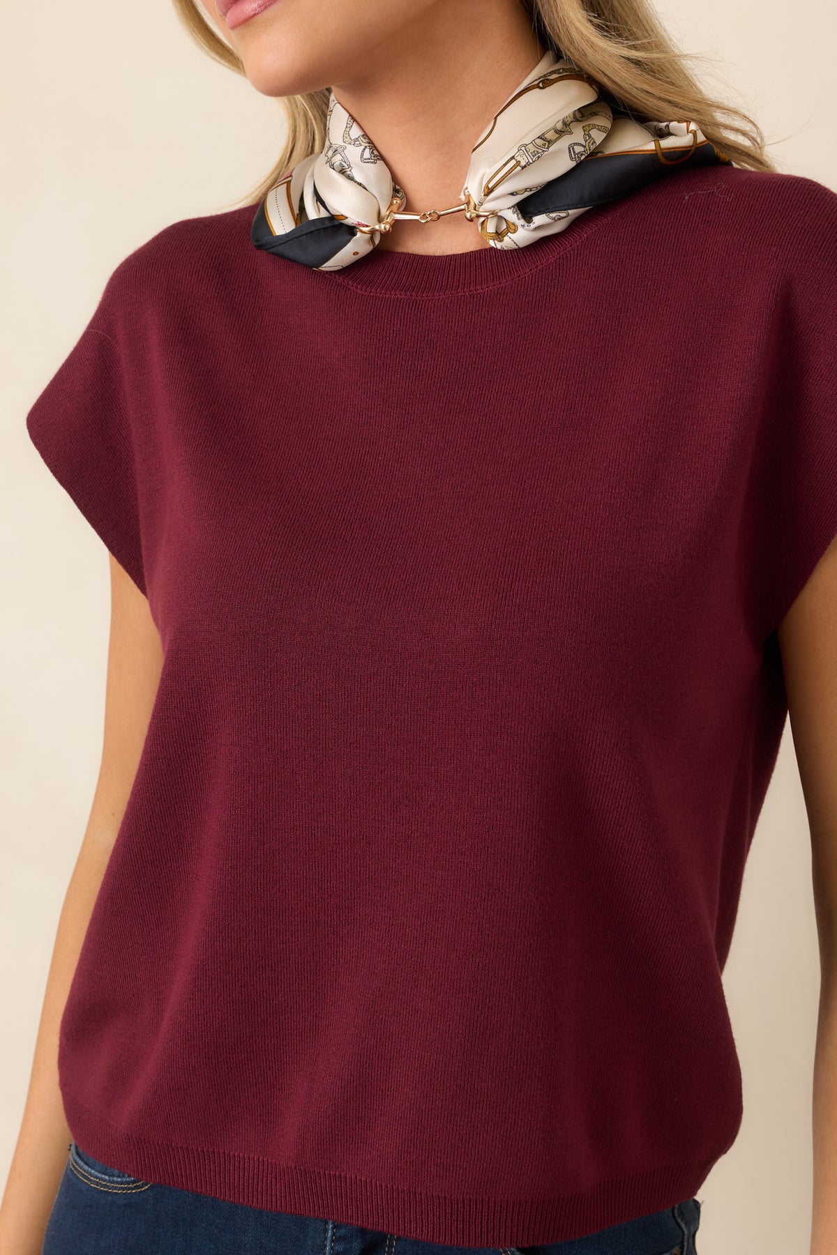 Close-up of the sweater highlighting the ribbed crew neckline, soft knit texture, and cleanly finished fabric.