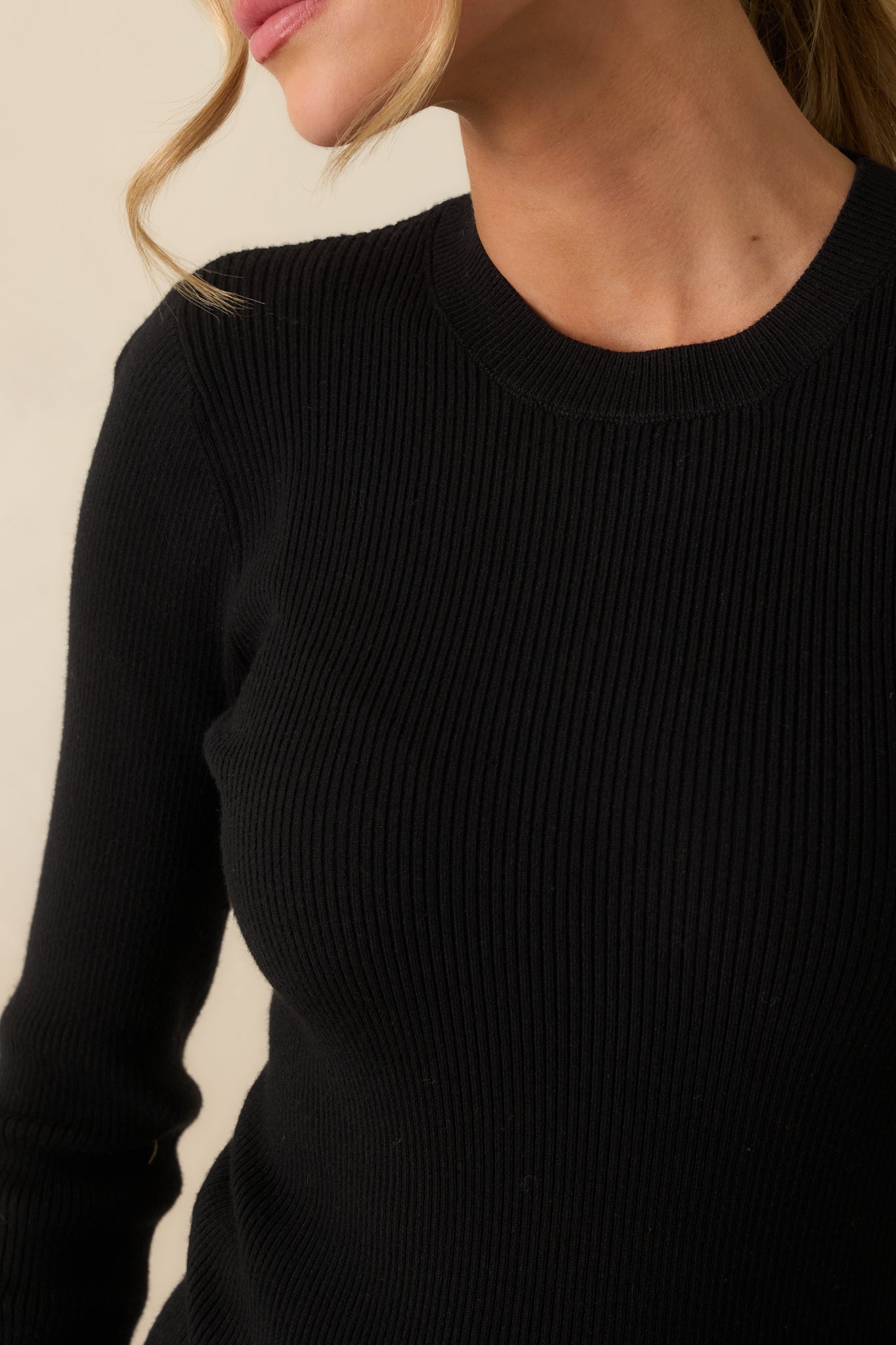 Detailed view of the ribbed knit fabric and crew neckline.