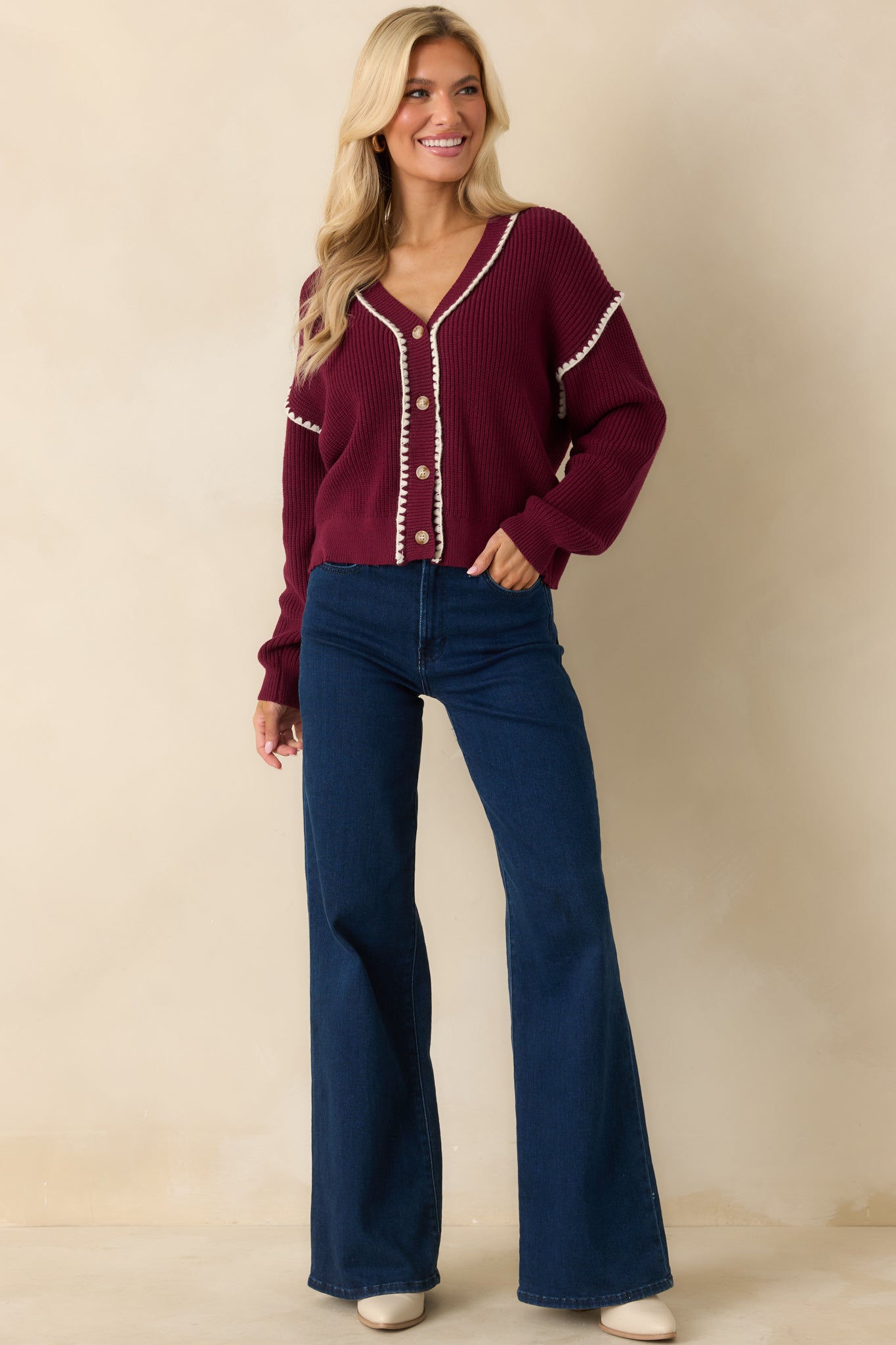 The ribbed knit construction is visible with the maroon fabric paired with crisp white trim along the neckline and cuffs.