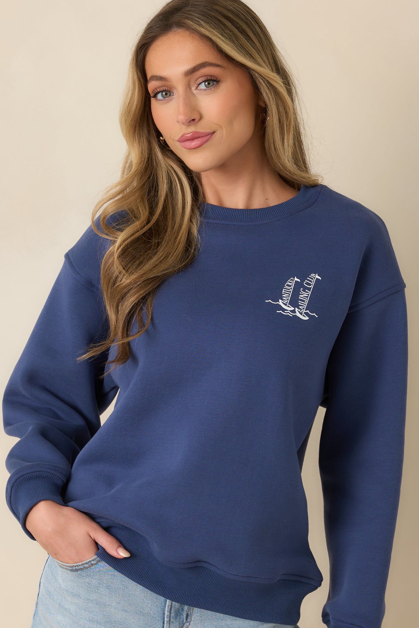 Ribbed neckline and soft washed fabric on relaxed navy sweatshirt.