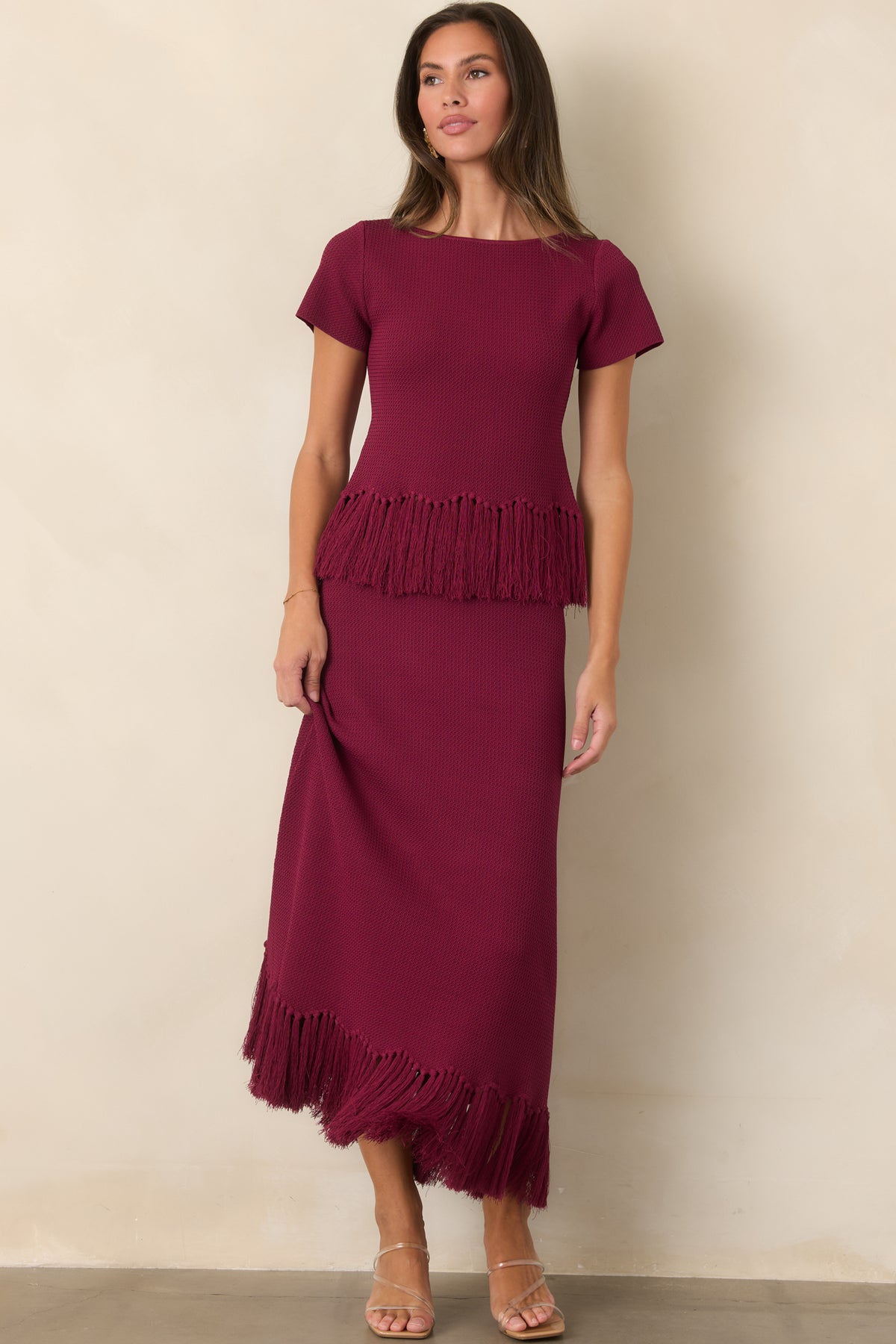 Rich berry skirt with a streamlined knit construction and fluid fringe-trimmed hem.