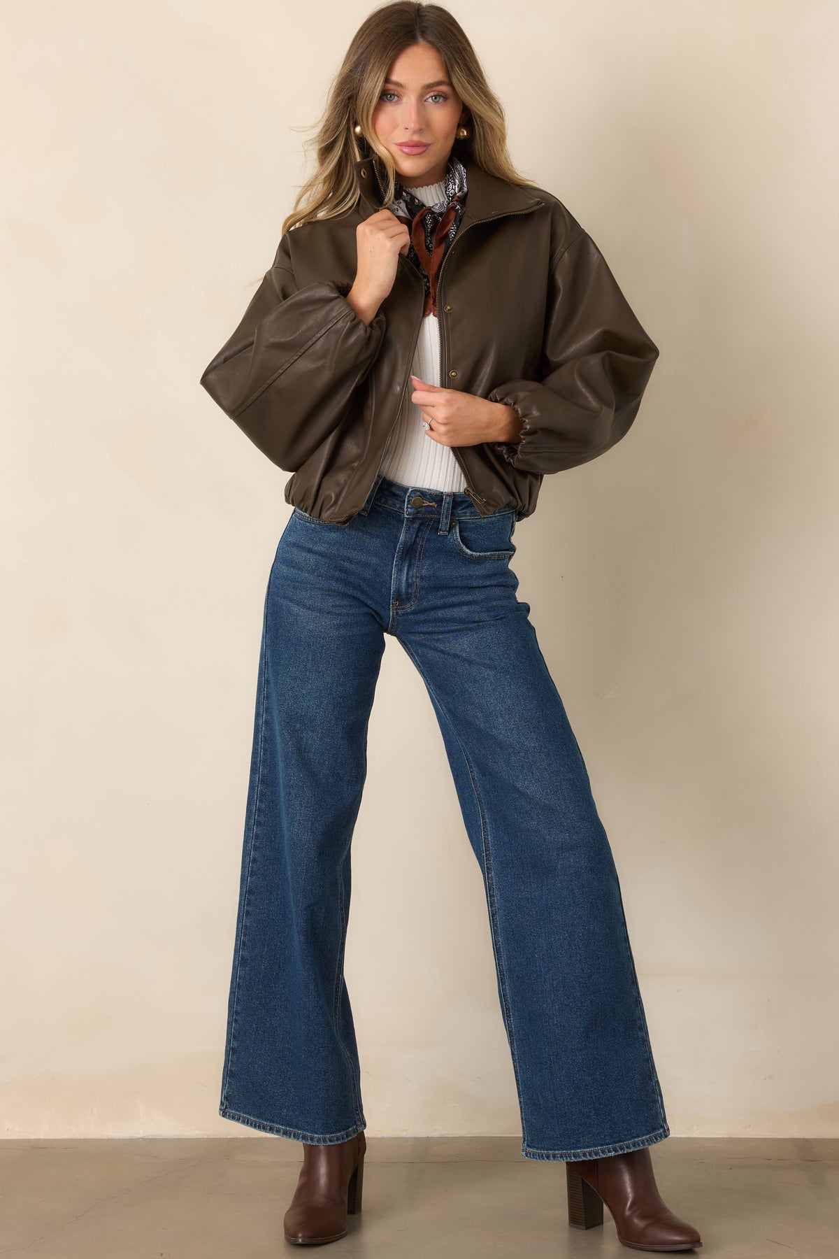 Rich blue wide leg jeans feature a high-rise waist, subtle fading, and classic five-pocket styling.