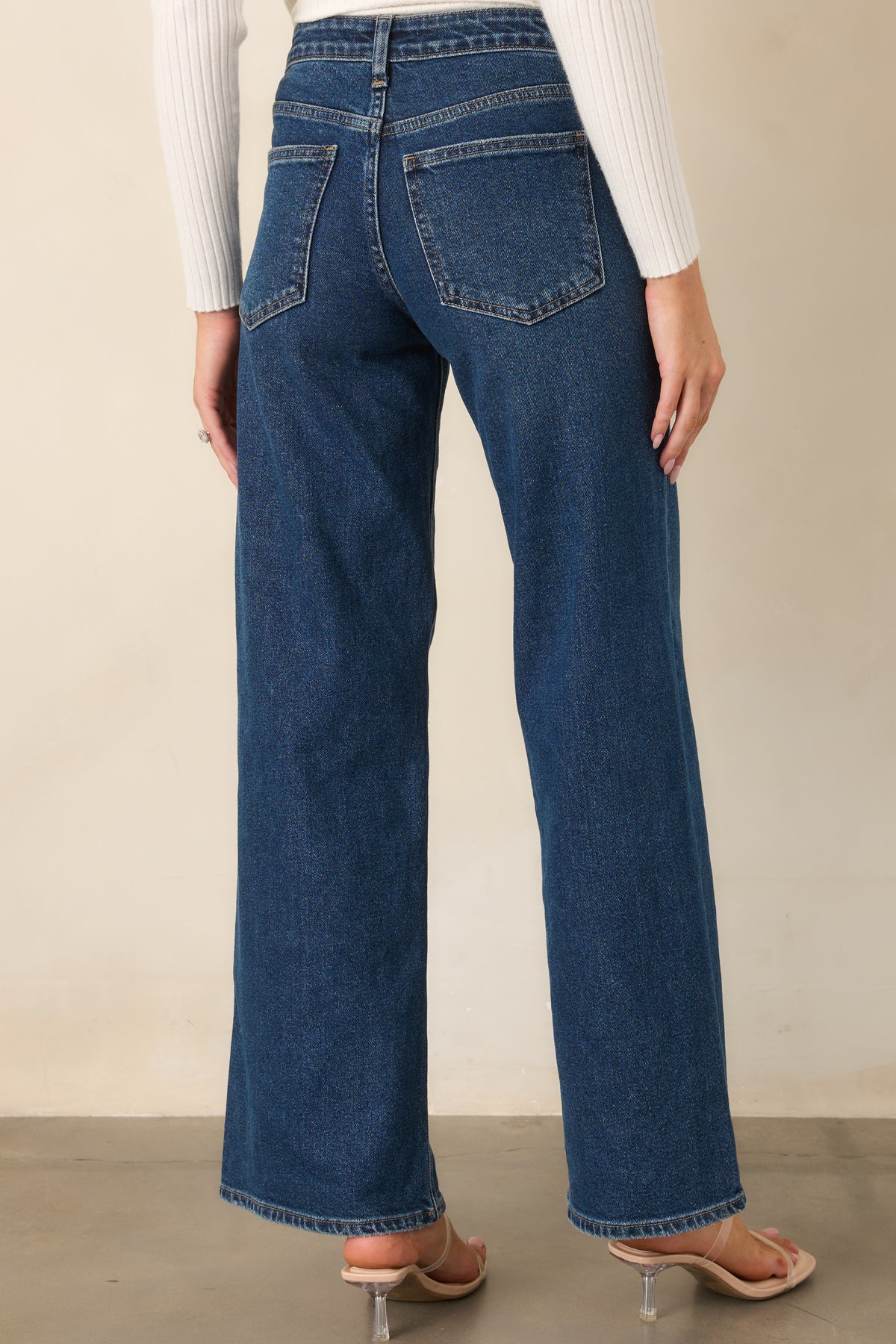 Rear of the rich blue wide leg jeans showcases the back pockets, high-rise waist, and subtle denim fading.