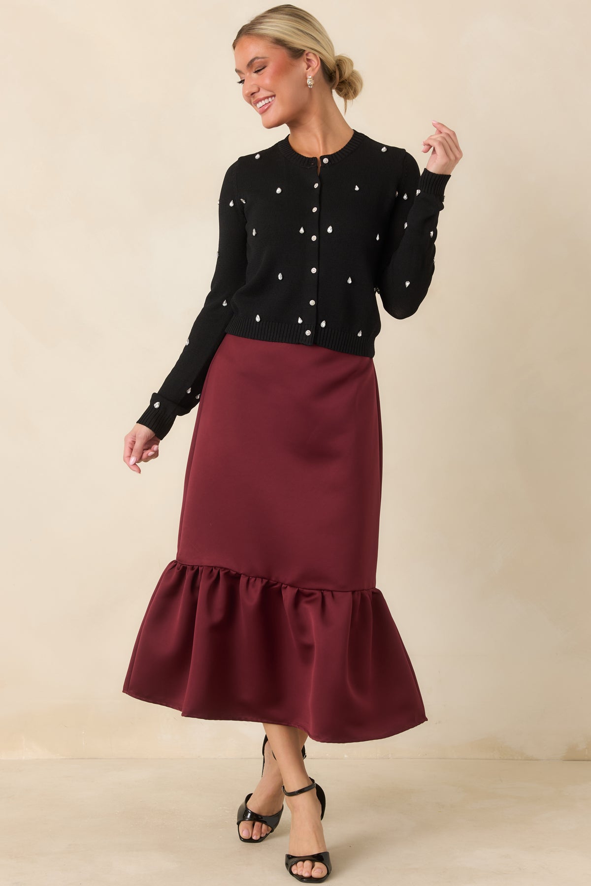 Rich burgundy skirt with a sleek satin finish and feminine gathered hemline.
