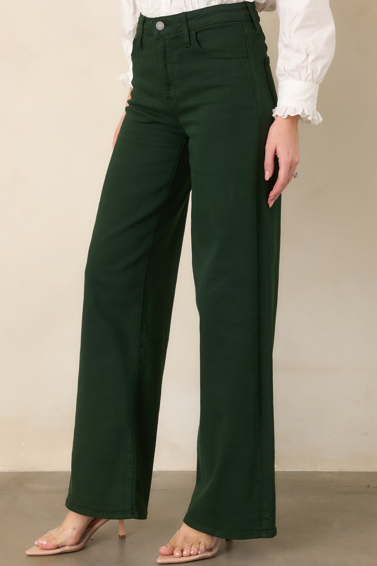Rich green pants showcasing the comfortable waistband, soft stretch denim, and clean construction of the upper silhouette.