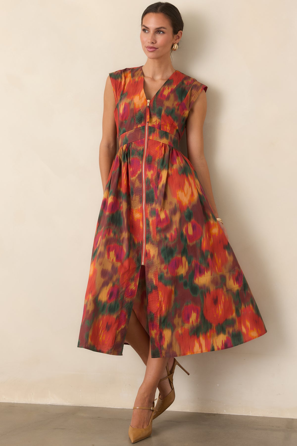 Rich rust floral dress featuring a V-neckline, fitted bodice, structured cap sleeves, gathered midi skirt, and smooth lining.