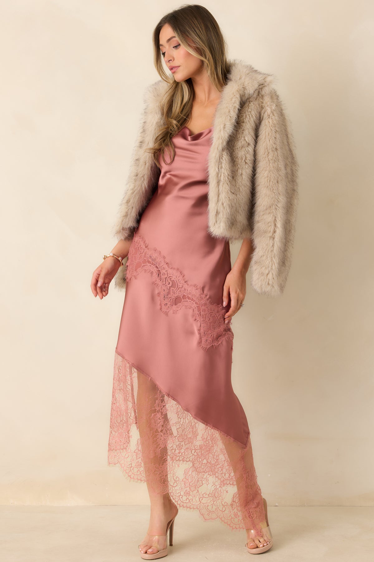 Satin rose pink dress with thin spaghetti straps, a fluid silhouette, and a sheer lace hem extension.