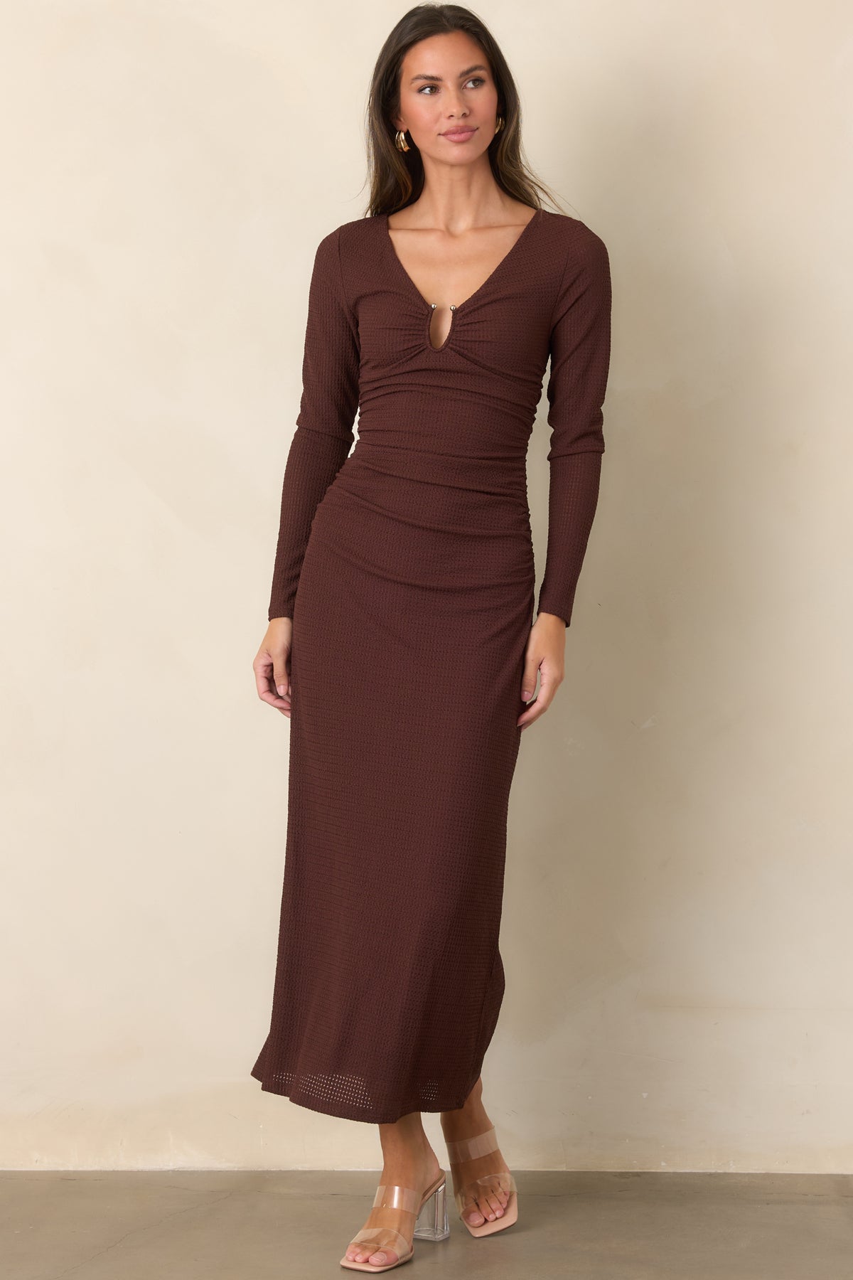 Curve-skimming midi dress showcases ruching through the bodice and waist, creating definition before falling into a softly flowing skirt.