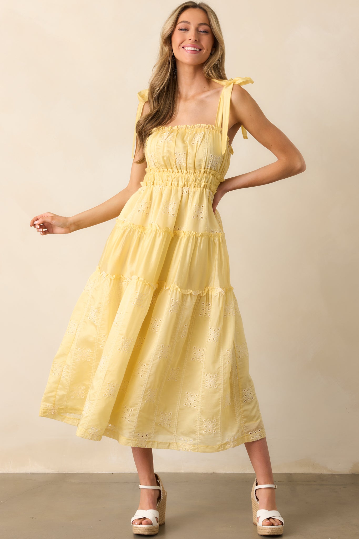 Ruffle trim details and airy embroidered fabric bring a playful, breezy feel to this yellow midi dress.