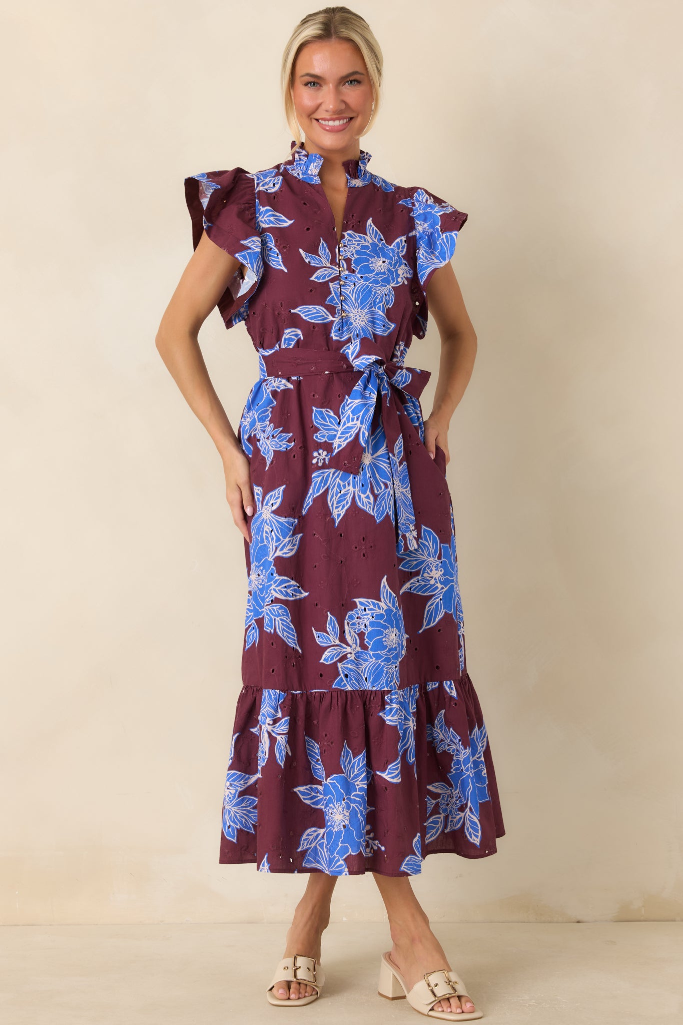 Ruffle-trimmed dress with a split V-neckline, adjustable self-tie waist belt, and a flowing hemline for added dimension.