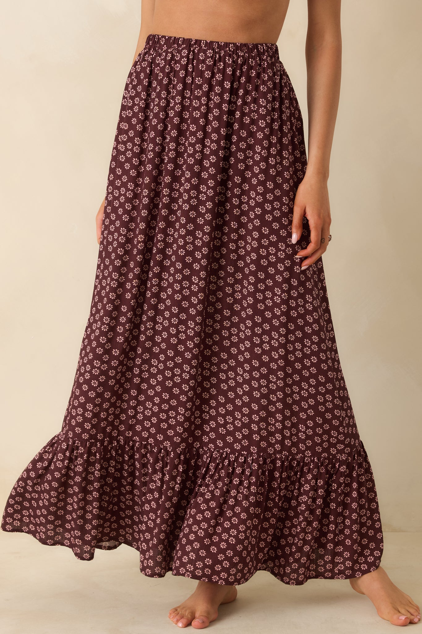 Ruffled hem of the burgundy skirt showcased with its lightweight, breezy texture.
