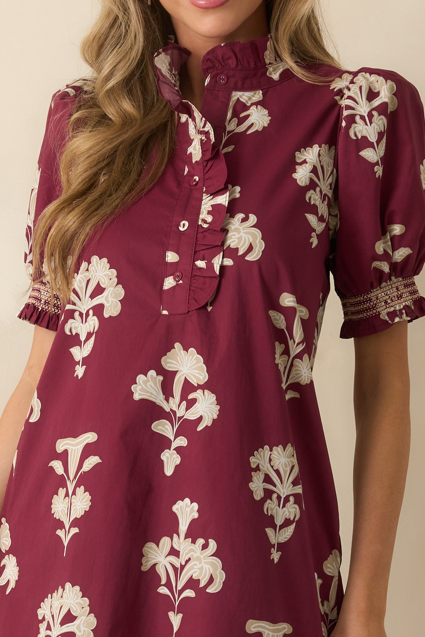 Ruffled mock neckline and quarter button placket with ruffle trim on the wine red floral maxi dress.