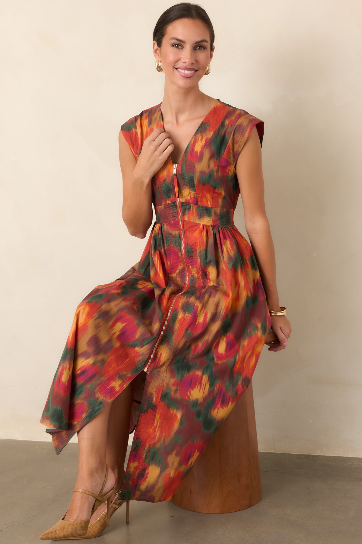 Floral midi dress in rich rust tones with a structured bodice, gathered skirt, gold-tone front zipper, and side pockets.